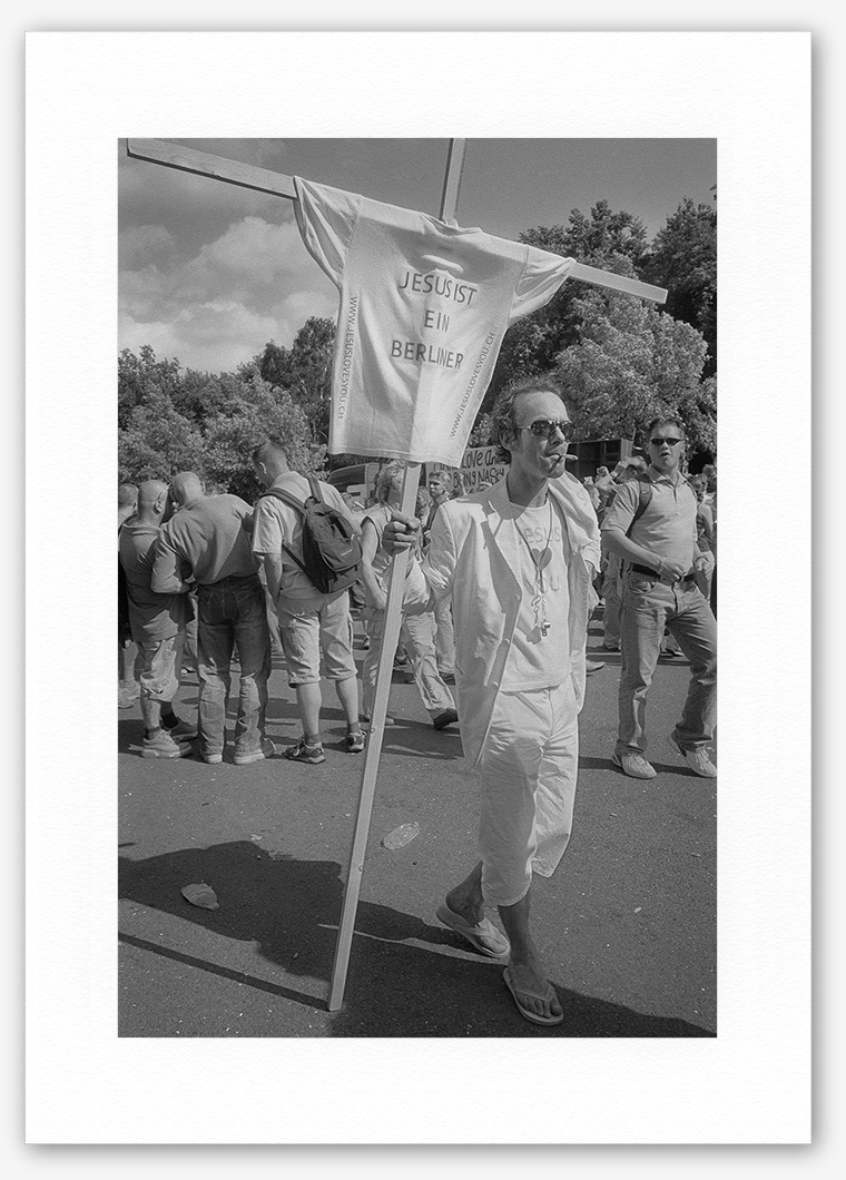 Steve Hanson photography. Man with Jesus banner, Love parade, Berlin, Germany.