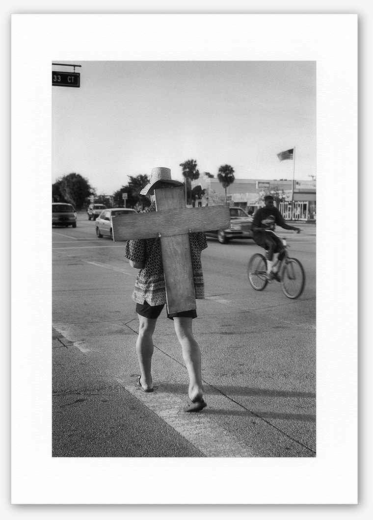 Steve Hanson photography. Man carrying a wooden cross, Florida, USA.