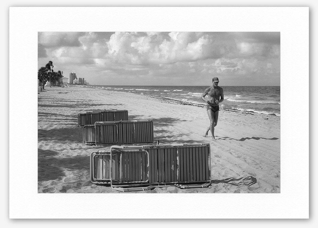 Steve Hanson photography. Man jogging along a beach, Florida, USA.