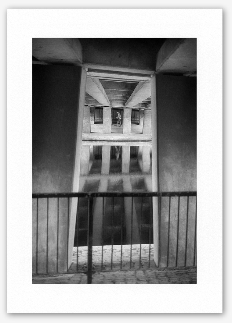 Steve Hanson photography. Man walking under a bridge, Leicester, England.