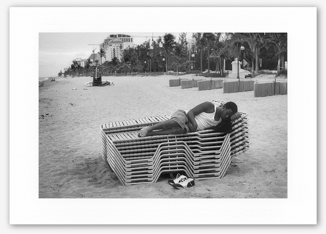 Steve Hanson photography. Man asleep on a beach, Florida, USA.