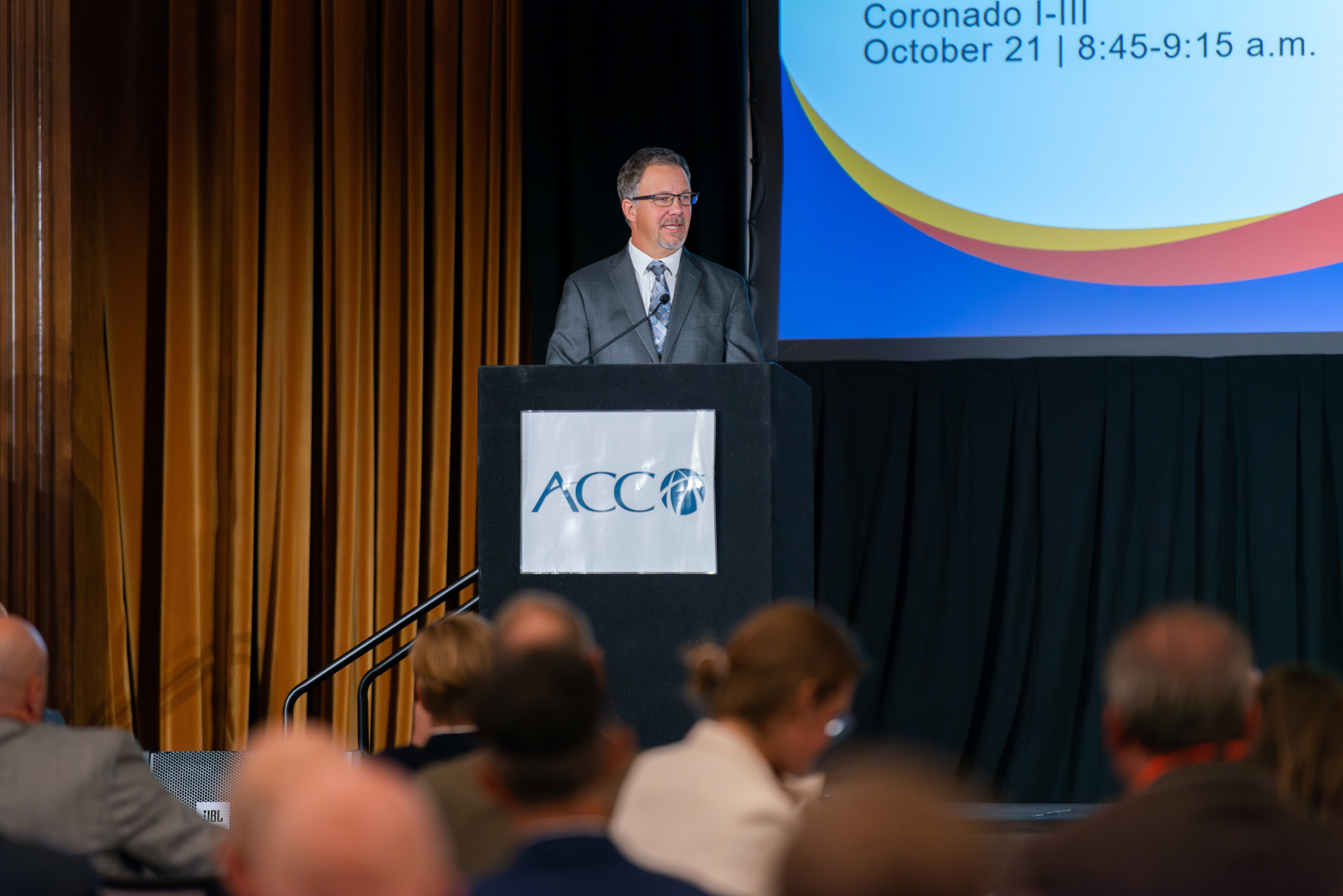 Corporate event photography capturing a speaker live in action