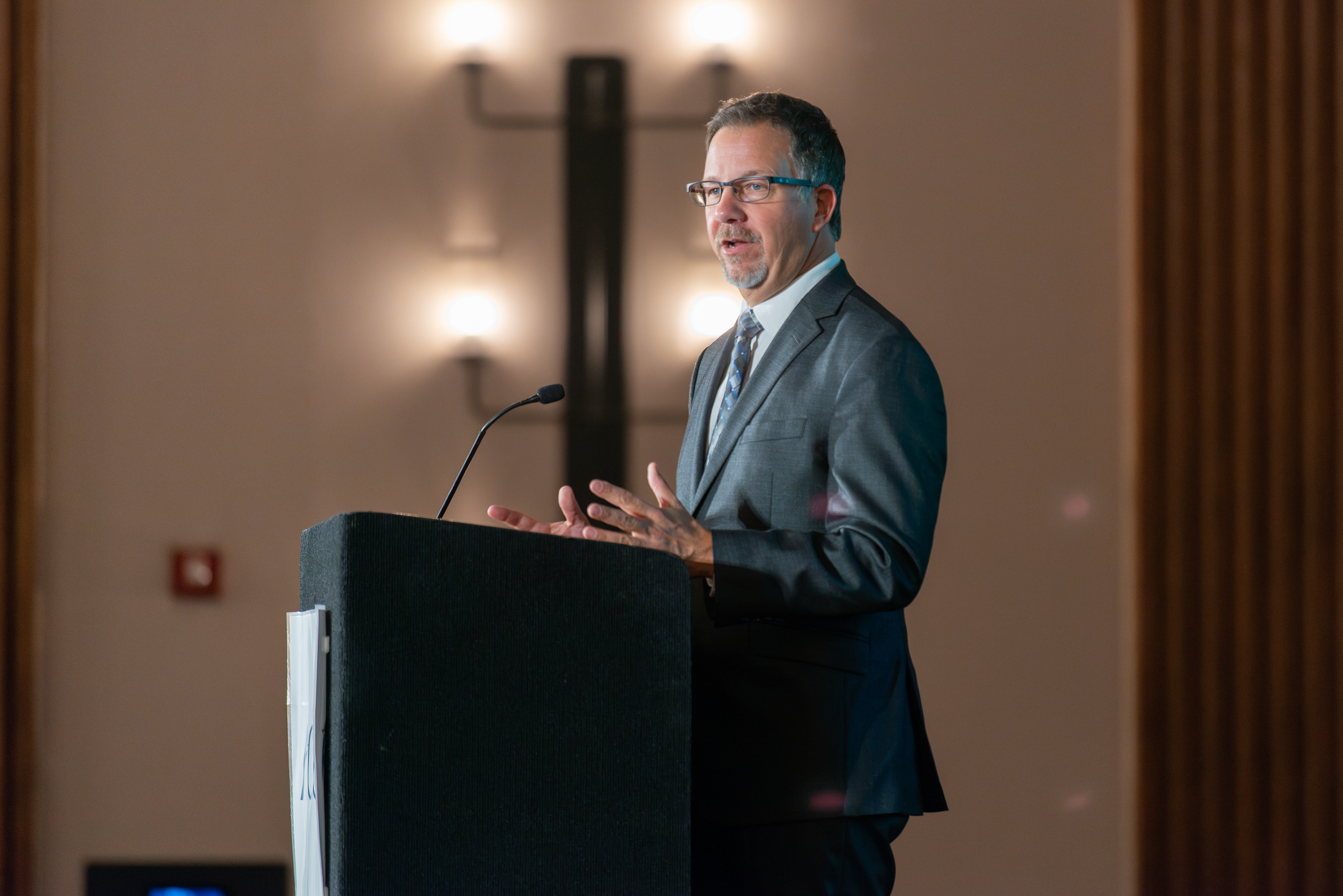 Corporate event photography capturing a speaker live in action