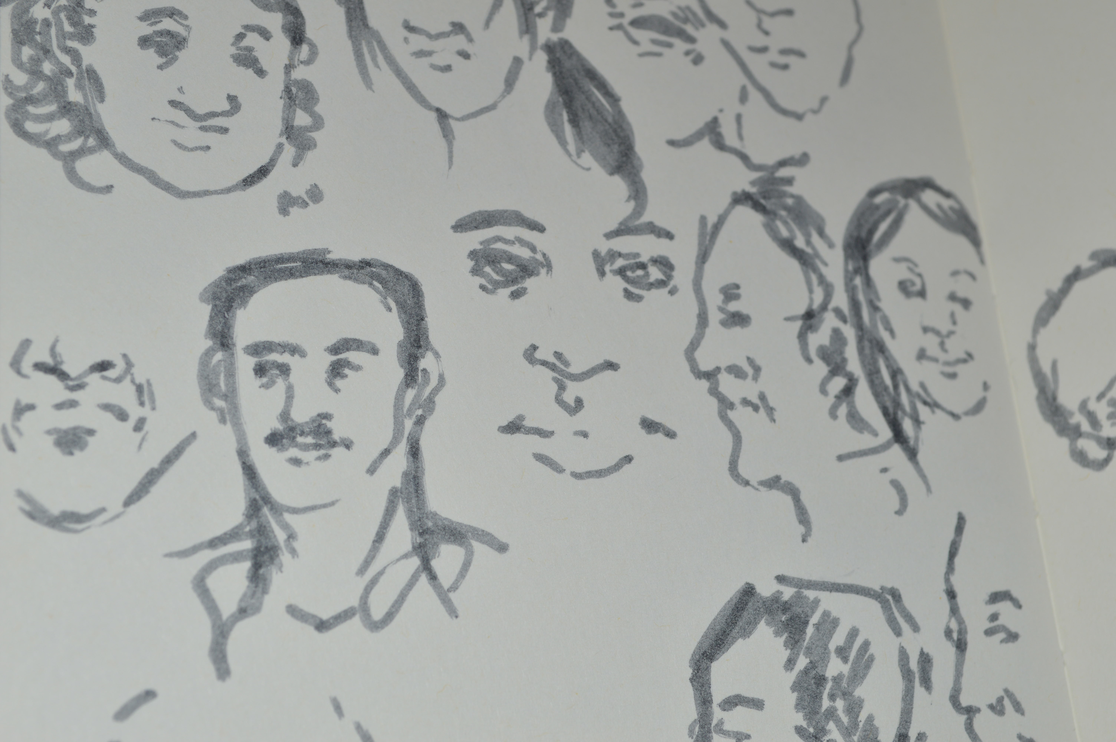 Deborah Ajia sketchbook faces and sketches in grey felt pen