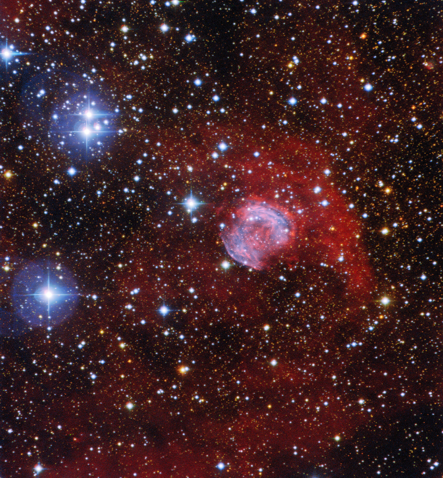 This image shows the planetary nebula Sh2-42 in the constellation Sagittarius, and was captured by using the SMARTS 0.9-meter Telescope at Cerro Tololo Inter-American Observatory, a Program of NSF’s NOIRLab. Despite the name, planetary nebulae have nothing to do with planets — they are spectacular funeral pyres formed by red giant stars at the end of their lives. As these giant stars expand and throw their outer gaseous layers into space, the hot exposed core of the star ionizes the surrounding material, causing it to glow in a range of vivid colours. As it reaches the end of its life, our own Sun is expected to form a planetary nebula — but not for another 5 billion years!  Credit: CTIO/NOIRLab/NSF/AURA Acknowledgment: Image processing: T. A. Rector (University of Alaska Anchorage/NSF’s NOIRLab), M. Zamani & D. de Martin (NSF’s NOIRLab)