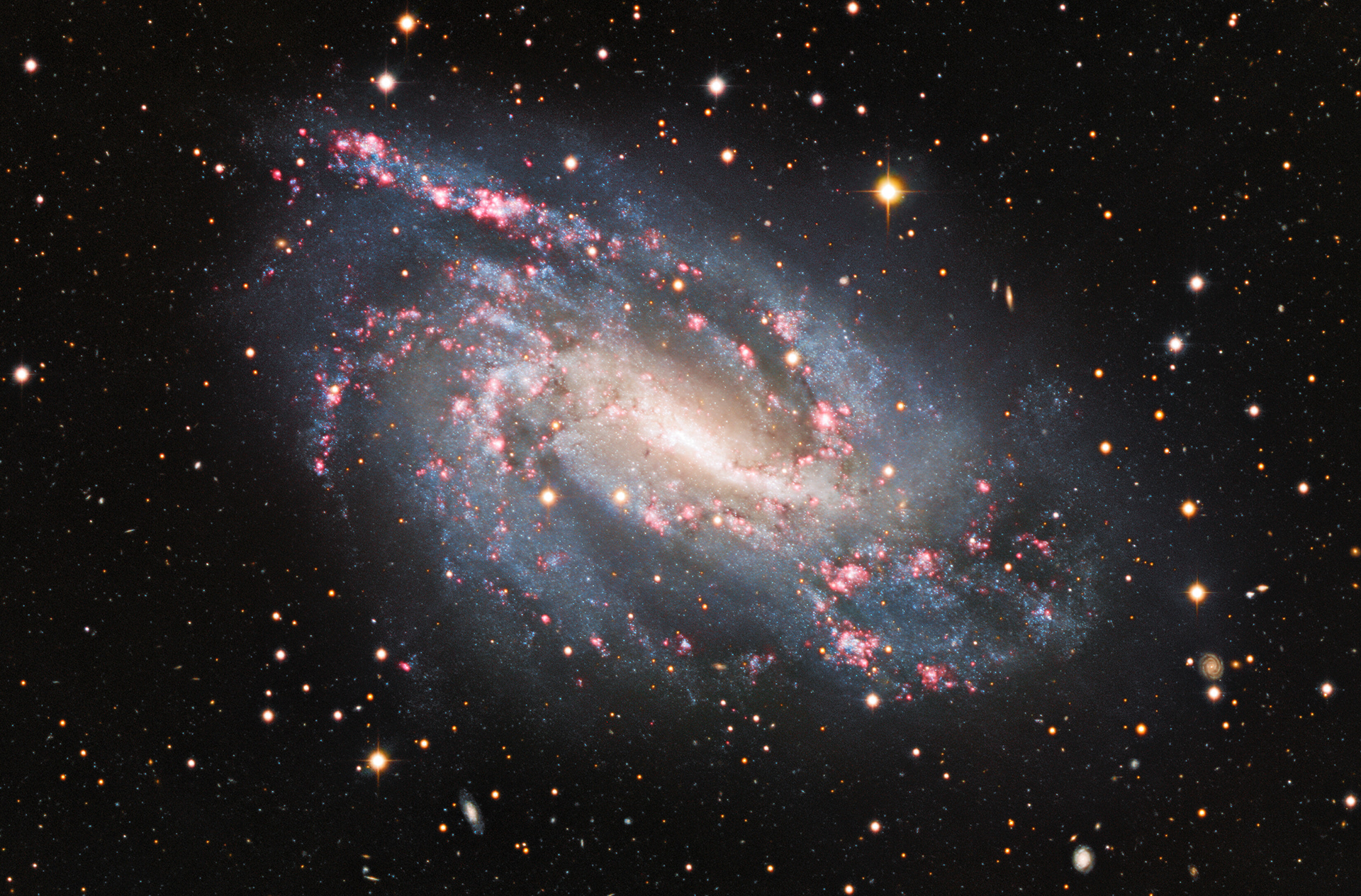 The spiral galaxy NGC 925 reveals cosmic pyrotechnics in its spiral arms where bursts of star formation are taking place in the red, glowing clouds scattered throughout it.   Credit: KPNO/NOIRLab/NSF/AURA  Acknowledgements: PI: M T. Patterson (New Mexico State University) Image processing: Travis Rector (University of Alaska Anchorage), Mahdi Zamani & Davide de Martin