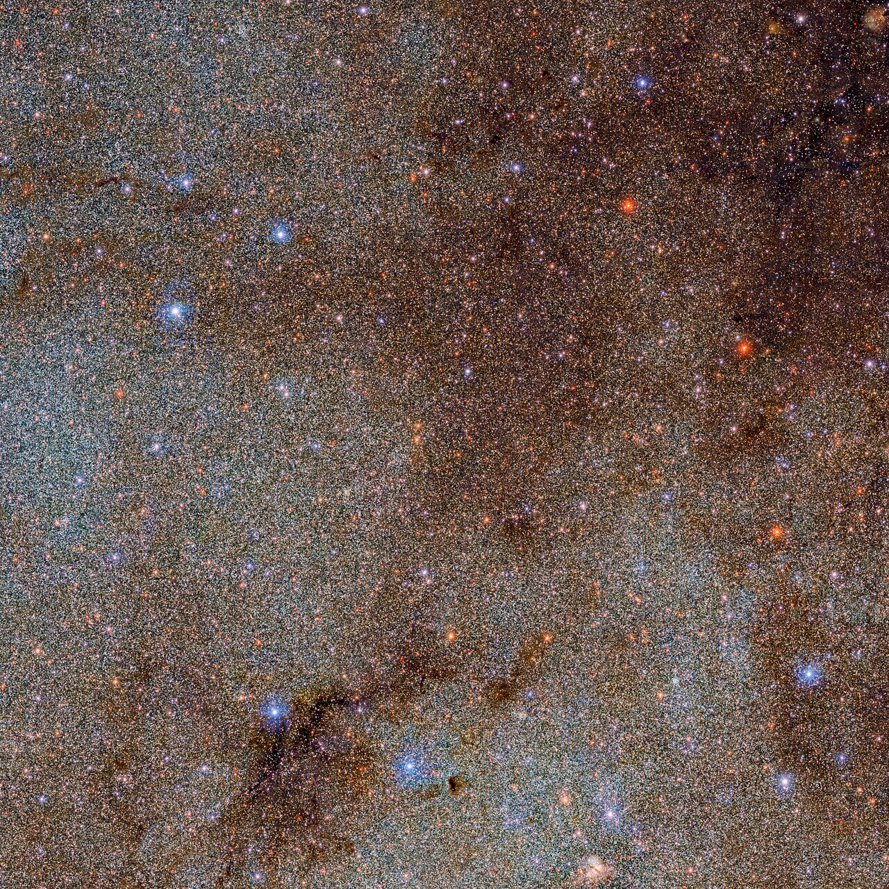 This image, which is brimming with stars and dark dust clouds, is a small extract — a mere pinprick — of the full Dark Energy Camera Plane Survey (DECaPS2) of the Milky Way. The new dataset contains a staggering 3.32 billion celestial objects — arguably the largest such catalog so far. The data for this unprecedented survey were taken with the US Department of Energy-fabricated Dark Energy Camera at the NSF’s Cerro Tololo Inter-American Observatory in Chile, a Program of NOIRLab.  Credit: DECaPS2/DOE/FNAL/DECam/CTIO/NOIRLab/NSF/AURA  Image processing: M. Zamani & D. de Martin (NSF’s NOIRLab)