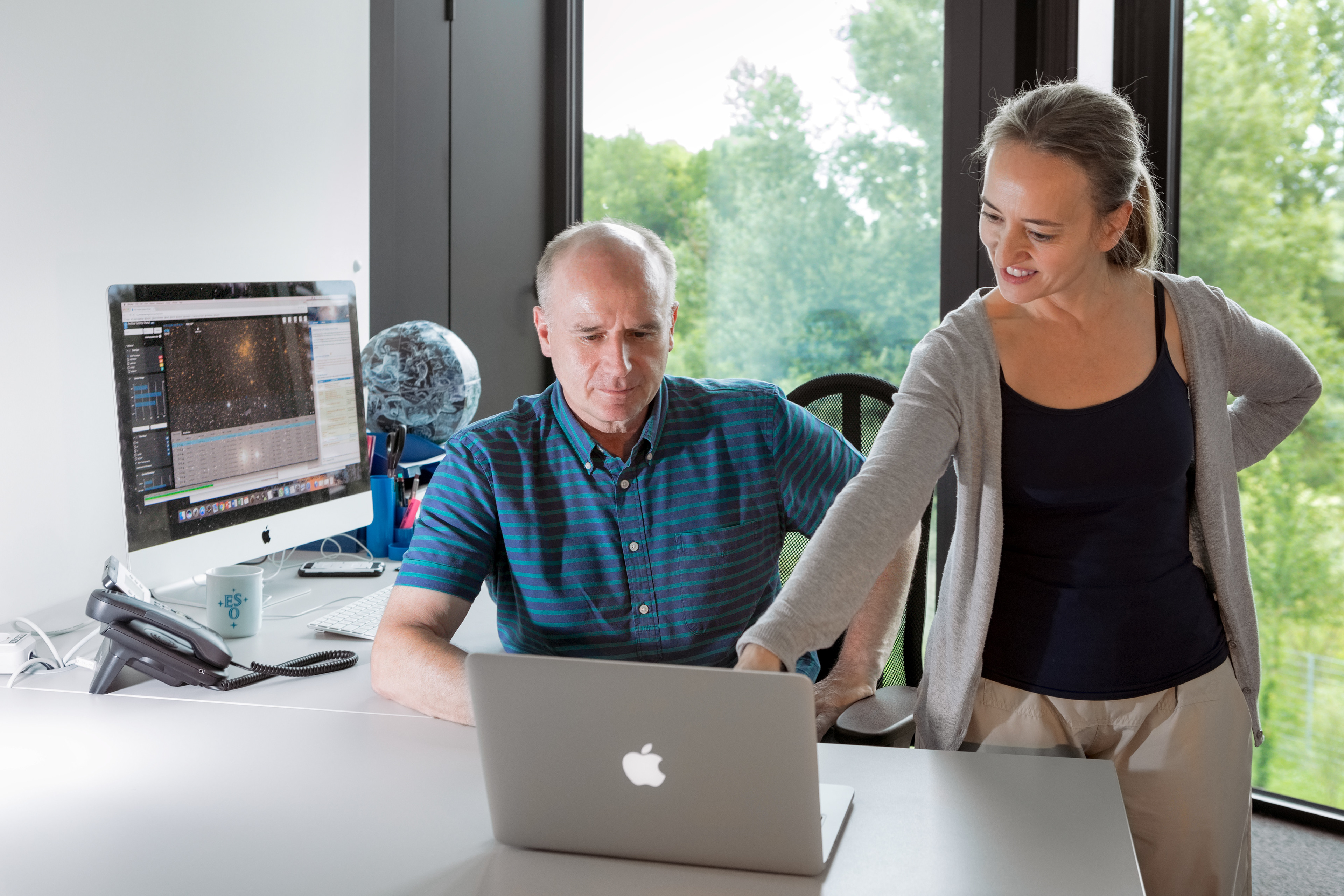 Two ESO astronomers are shown accessing the ESO Archive Science Portal, which was developed for easier, more intuitive use of the ESO Science Archive.