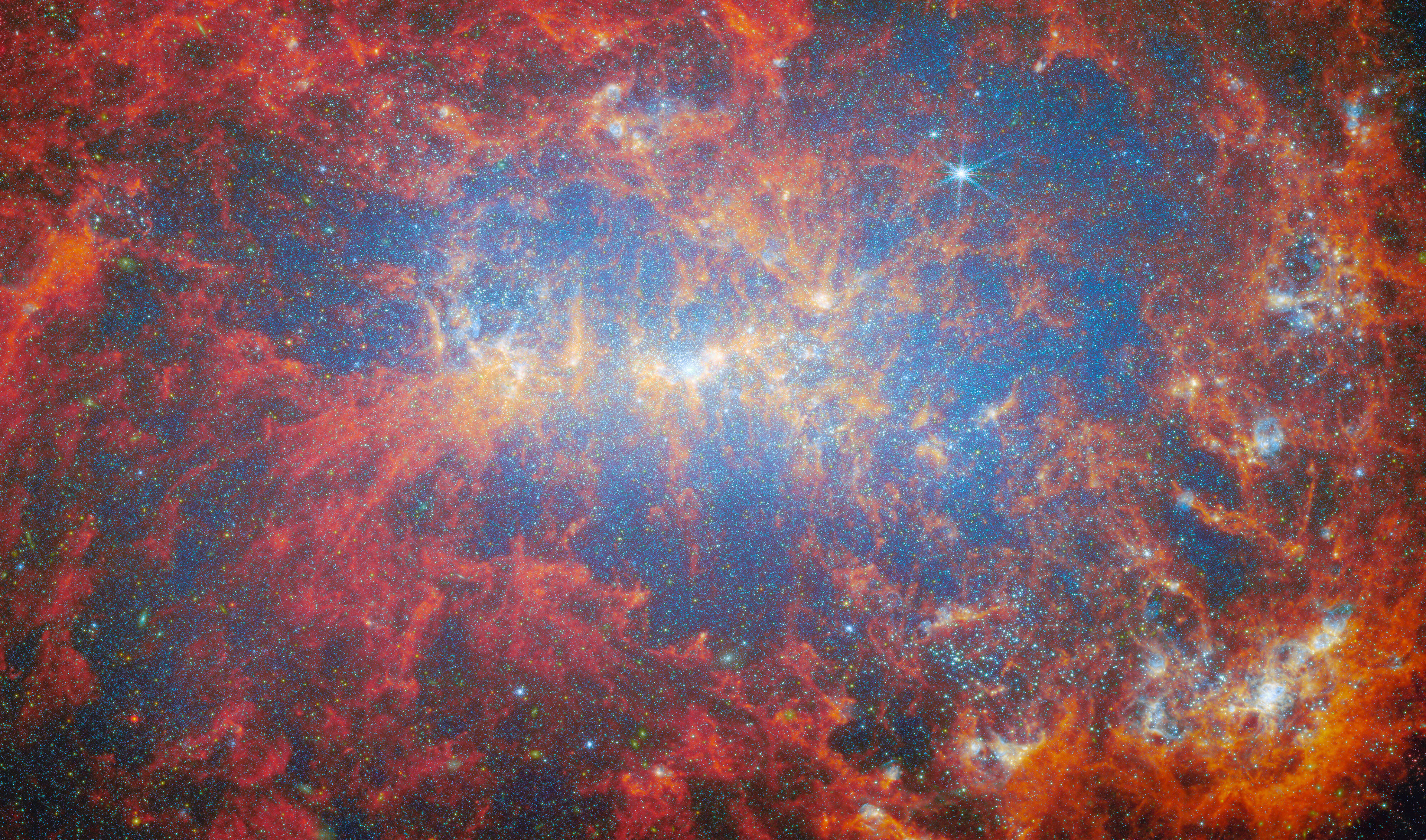 Fireworks of stellar starbursts - Credit: ESA/Webb, NASA & CSA, A. Adamo (Stockholm University) and the FEAST JWST team