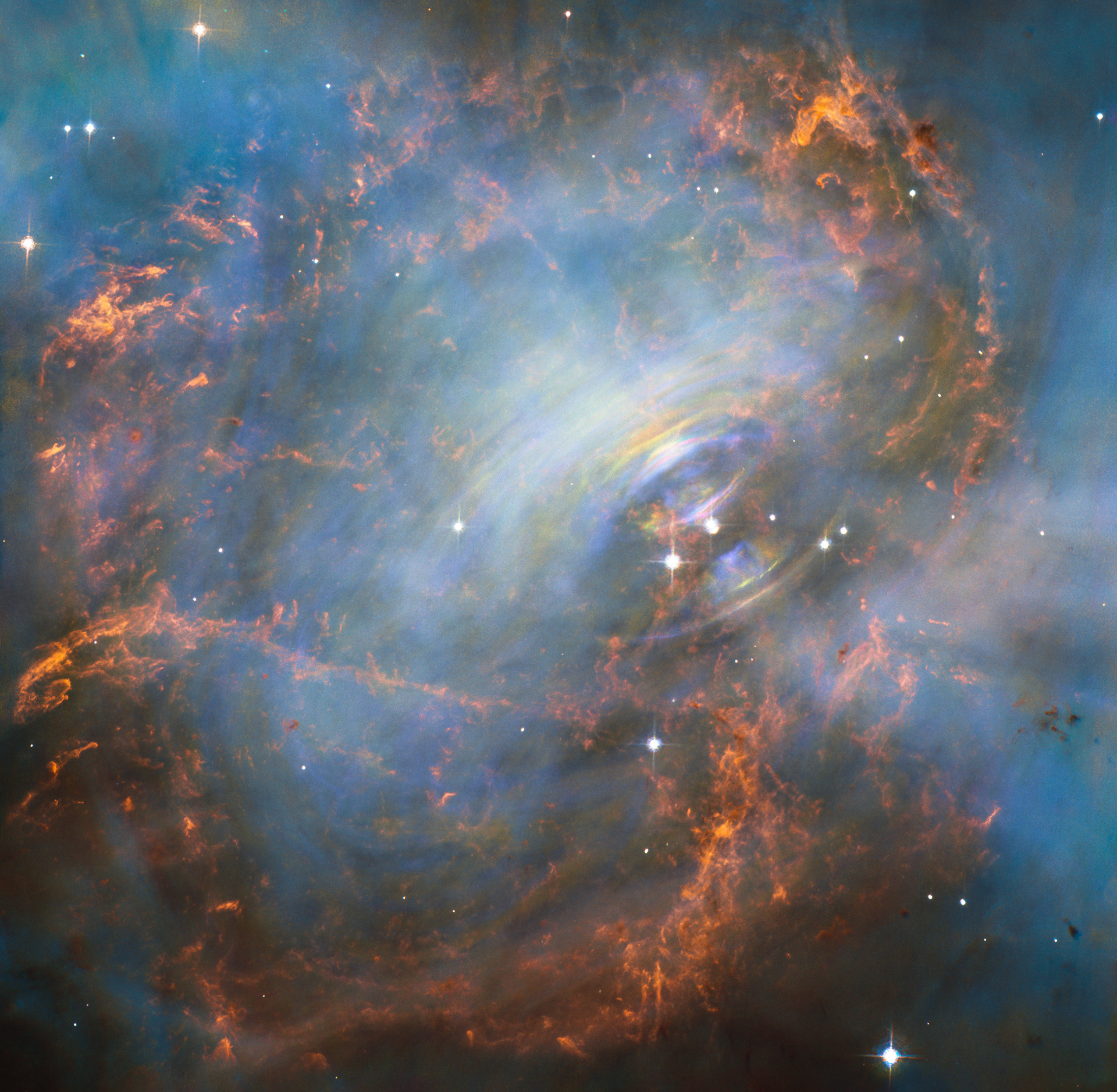 Moving heart of the Crab Nebula / While many other images of the famous Crab Nebula have focused on the filaments in the outer part of the nebula, this image shows the very heart of the Crab Nebula including the central neutron star — it is the rightmost of the two bright stars near the centre of this image.  The rapid motion of the material nearest to the central star is revealed by the subtle rainbow of colours in this time-lapse image, the rainbow effect being due to the movement of material over the time between one image and another.  Credit: NASA, ESA 