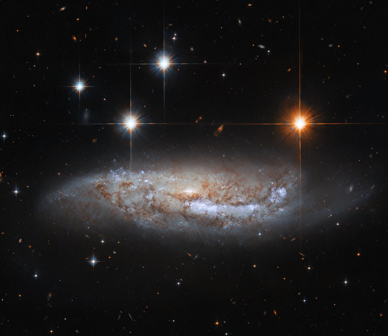 In this image, the NASA/ESA Hubble Space Telescope captures a side-on view of NGC 3568, a barred spiral galaxy roughly 57 million light-years from the Milky Way in the constellation Centaurus. In 2014 the light from a supernova explosion in NGC 3568 reached Earth — a sudden flare of light caused by the titanic explosion accompanying the death of a massive star. Whilst most astronomical discoveries are the work of teams of professional astronomers, this supernova was discovered by amateur astronomers from the Backyard Observatory Supernova Search in New Zealand. Dedicated amateur astronomers often make intriguing discoveries — particularly of fleeting astronomical phenomena such as supernovae.   This Hubble observation comes from a hoard of data built up to pave the way for future science with the upcoming NASA/ESA/CSA James Webb Space Telescope. By combining ground-based observations with data from Hubble’s Advanced Camera for Surveys and Wide Field Camera 3, astronomers have built a treasure trove of data on the connections between young stars and the clouds of cold gas in which they form. One of Webb’s key science goals is to explore the life cycle of stars — particularly how and where stars are born. Since Webb observes at infrared wavelengths, it will be able to peer through the clouds of gas and dust in stellar nurseries and observe the fledgling stars within. Webb’s superb sensitivity will even allow astronomers to directly investigate faint protostellar cores — the earliest stages of star birth.  Credit: ESA/Hubble & NASA, M. Sun