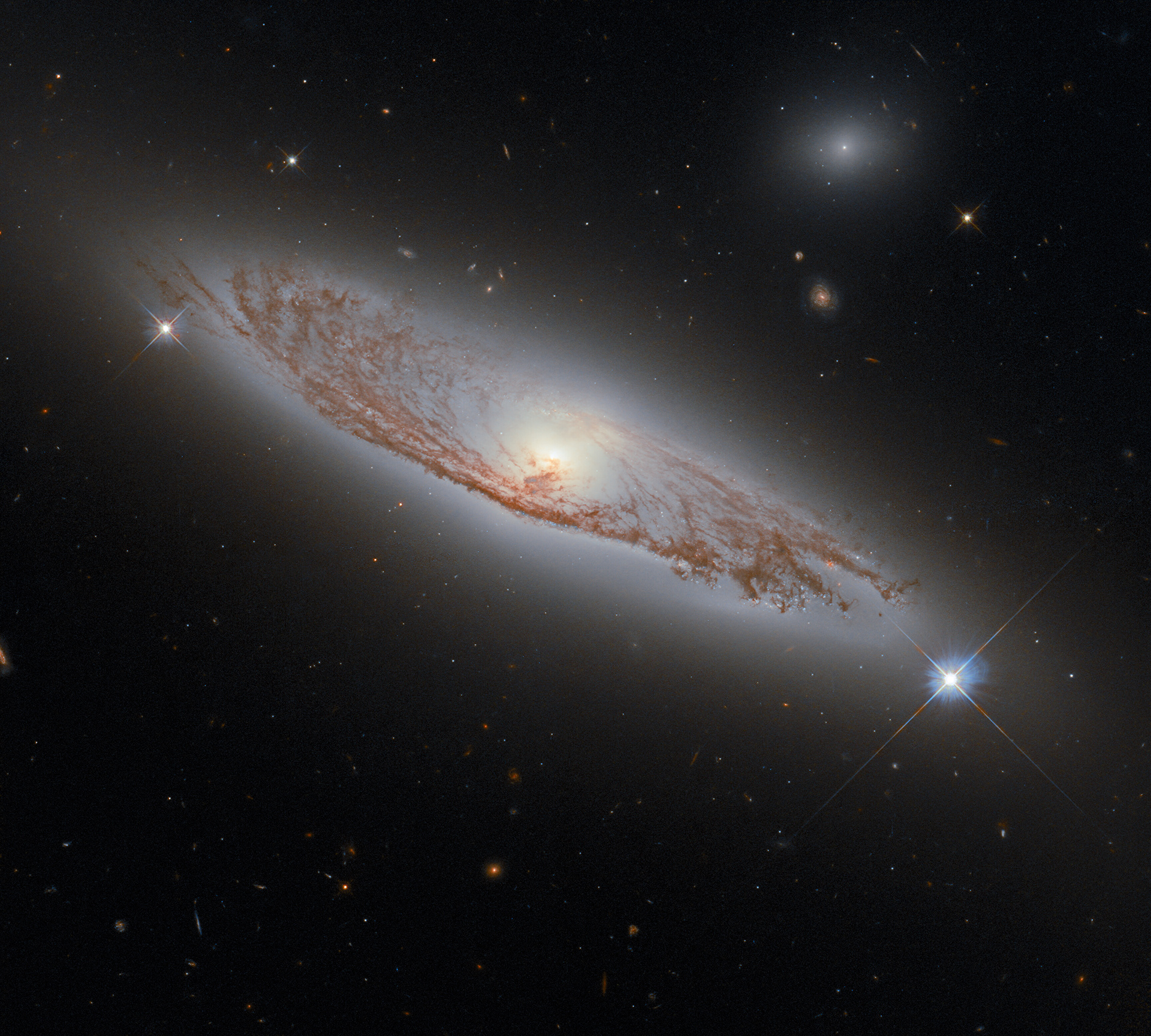 This image shows the spiral galaxy NGC 5037, which is found in the constellation of Virgo and was first documented by William Herschel in 1785. It lies about 150 million light-years away from Earth, and yet it is possible to see the delicate structures of gas and dust within the galaxy in extraordinary detail. This was made possible by Hubble’s Wide Field Camera 3 (WFC3), which was used to collect the exposures that were combined to create this image.   WFC3 is a very versatile camera, as it can collect ultraviolet, visible and infrared light, thereby providing a wealth of information about the objects that it observes. WFC3 was installed on Hubble by astronauts in 2009, during servicing mission 4, which was Hubble’s fifth and final servicing mission. Servicing mission 4 was intended to prolong Hubble’s life for another five years. 12 years later, both Hubble and WFC3 remain in active use!  Credit: ESA/Hubble & NASA, D. Rosario Acknowledgement: L. Shatz