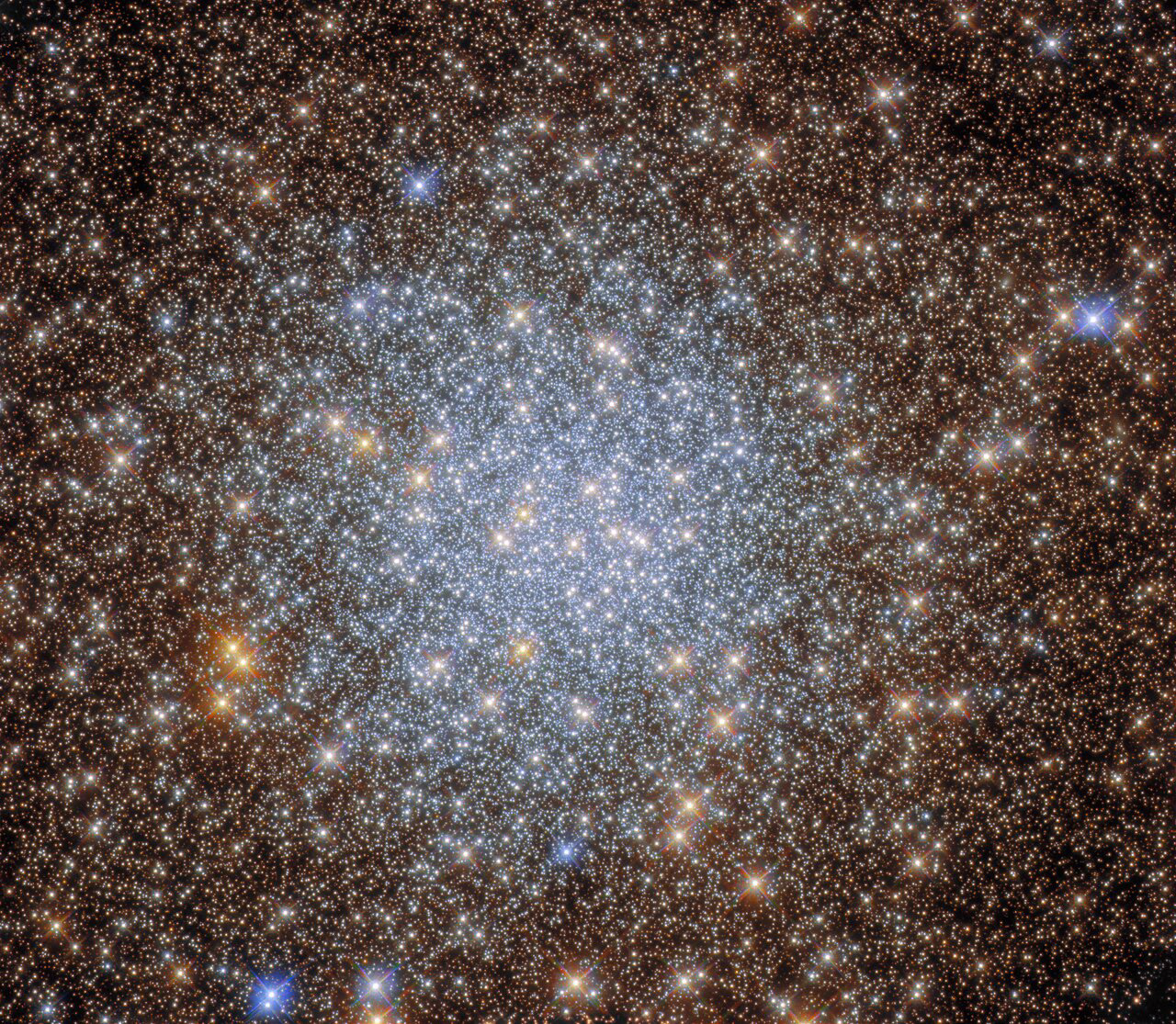 This image from the NASA/ESA Hubble Space Telescope captures the sparkling globular cluster NGC 6569 in the constellation Sagittarius. Hubble explored the heart of this cluster with both its Wide Field Camera 3 and Advanced Camera for Surveys, revealing a glittering hoard of stars in this astronomical treasure trove.   Globular clusters are stable, tightly bound clusters containing tens of thousands to millions of stars, and are associated with all types of galaxies. The intense gravitational attraction of these closely packed clusters of stars means that globular clusters have a regular spherical shape with a densely populated centre — as can be seen in the heart of this star-studded image.  This observation comes from an investigation of globular clusters which lie close to the centre of the Milky Way. These objects have been avoided in previous surveys, as the dust spread throughout  the centre of our galaxy blocks light from these globular clusters and alters the colours of the stars residing in them. The last factor is particularly important for astronomers studying stellar evolution, as the colours of stars can give astronomers insights into their ages, compositions, and temperatures.   The astronomers who proposed these observations combined data from Hubble with data from astronomical archives, allowing them to measure the ages of globular clusters including NGC 6569. Their research also provided insights into the structure and density of globular clusters towards the centre of the Milky Way.  Links Video of A Delving into an Astronomical Treasure Trove Credit:  ESA/Hubble & NASA, R. Cohen