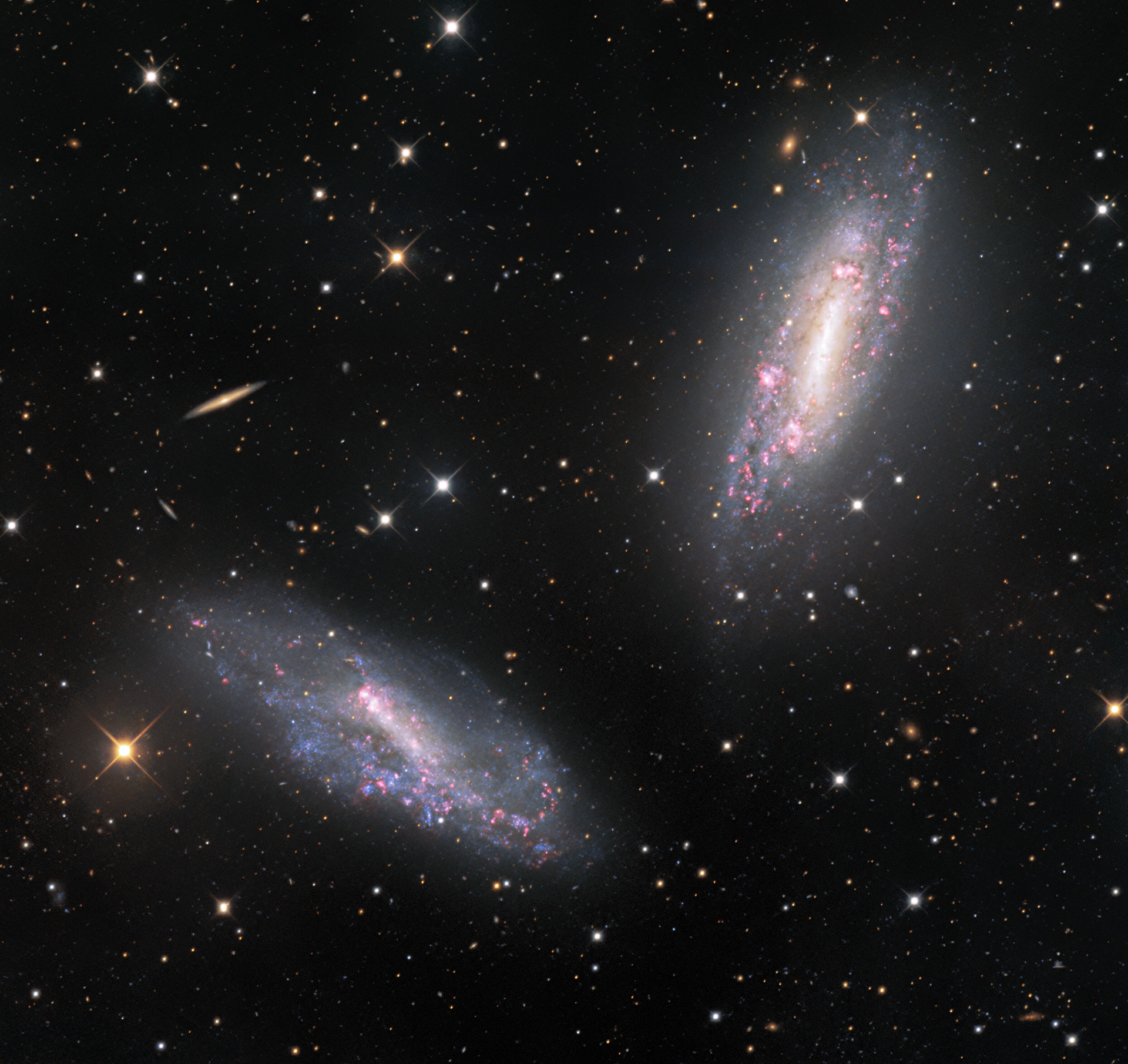 The two galaxies in this image — NGC 672 (top right) and IC 1727 (bottom left) — appear to be so close that they are almost elbowing each other, like playful children. In fact, the galaxies shown in this beautifully detailed image taken at the Kitt Peak National Observatory, a program of NSF’s NOIRLab, are classified as a galactic pair, and the gravity of each galaxy influences the other. The pair are located around 20 million light-years away from Earth and the space between them spans over 80,000 light-years, a seemingly enormous gap. However, from the perspective of the galaxies’ themselves, that separation is not so significant, as it is roughly equivalent to the size of the galaxies themselves.  Credit: KPNO/NOIRLab/NSF/AURA  Acknowledgements: PI: M T. Patterson (New Mexico State University) Image processing: Travis Rector (University of Alaska Anchorage), Mahdi Zamani & Davide de Martin