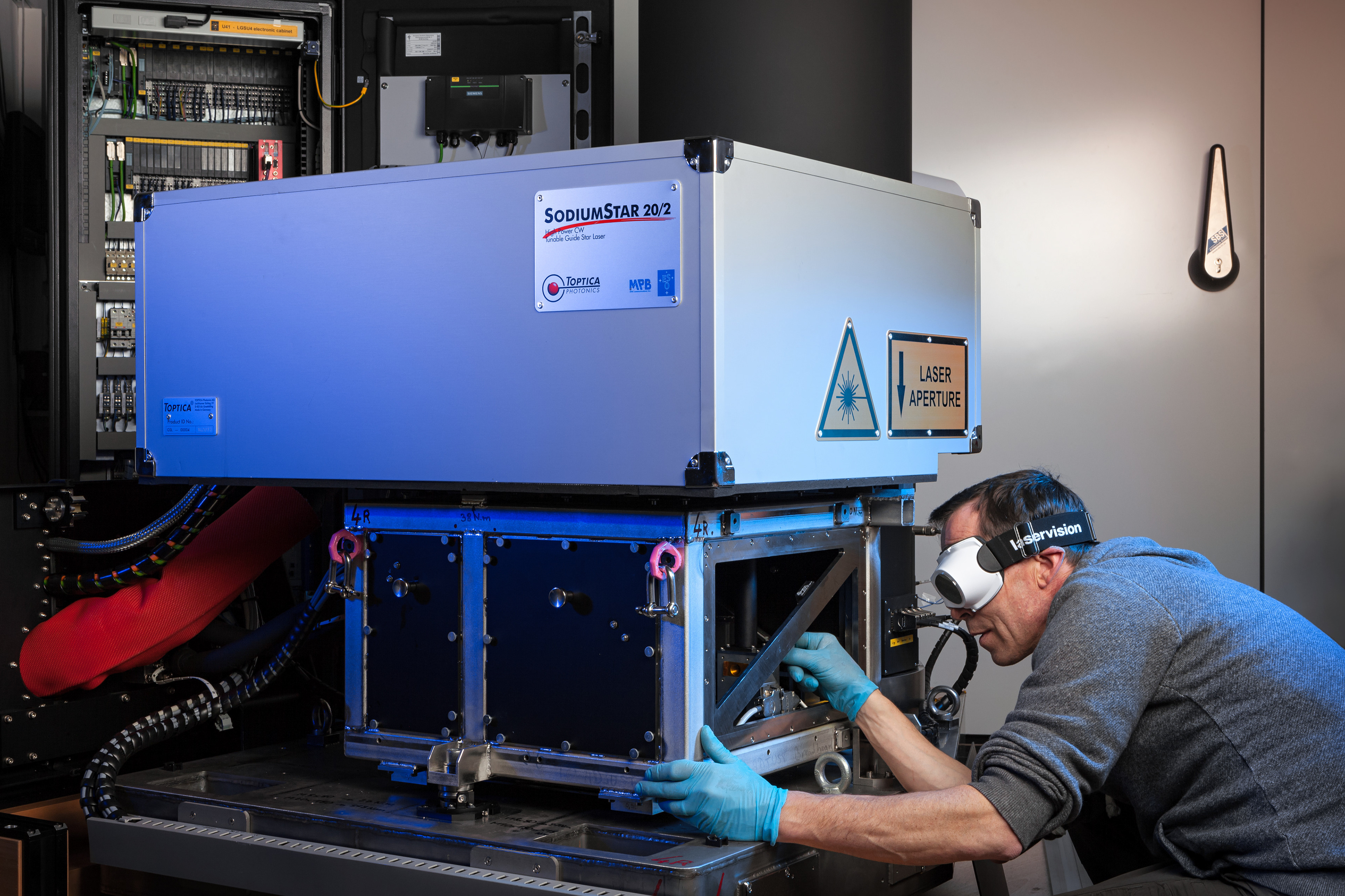 All four laser units that form the Four Laser Guide Star Facility — a core part of the Adaptive Optics Facility for ESO’s Very Large Telescope — were accepted by ESO and shipped to Chile in November 2015. This is a major step towards establishing the VLT Unit Telescope 4 as a fully adaptive telescope with much enhanced image quality.  This picture shows one of the units undergoing final testing by Christophe Dupuy, Integration hall manager, shortly before it was packed for shipping.