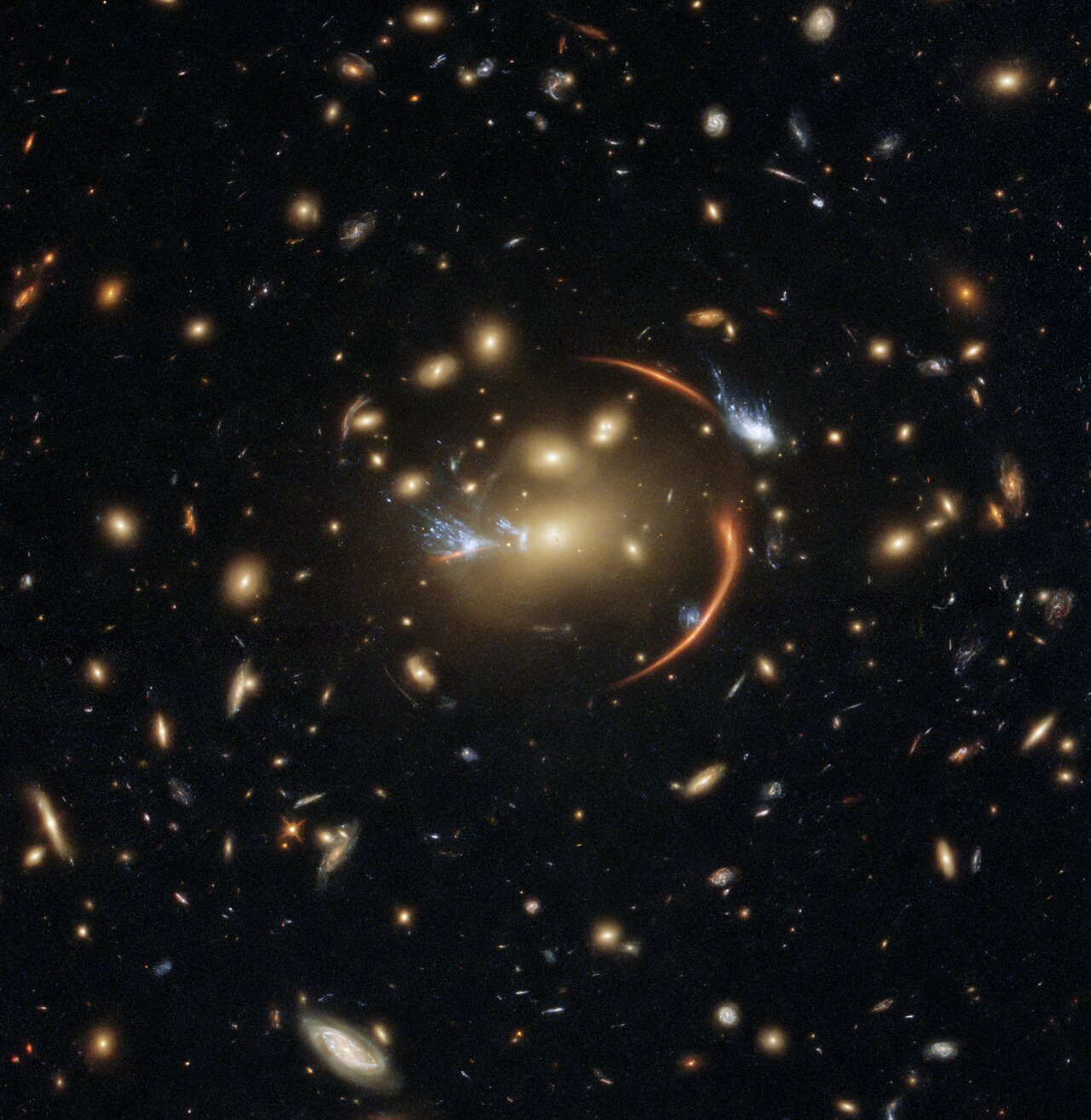 The centre of this image from the NASA/ESA Hubble Space Telescope is framed by the tell-tale arcs that result from strong gravitational lensing, a striking astronomical phenomenon which can warp, magnify, or even duplicate the appearance of distant galaxies.   Gravitational lensing occurs when light from a distant galaxy is subtly distorted by the gravitational pull of an intervening astronomical object. In this case, the relatively nearby galaxy cluster MACSJ0138.0-2155 has lensed a significantly more distant quiescent galaxy — a slumbering giant known as MRG-M0138 which has run out of the gas required to form new stars and is located 10 billion light years away. Astronomers can use gravitational lensing as a natural magnifying glass, allowing them to inspect objects like distant quiescent galaxies which would usually be too difficult for even Hubble to resolve.  This image was made using observations from eight different infrared filters spread across two of Hubble’s most advanced astronomical instruments: the Advanced Camera for Surveys and the Wide Field Camera 3. These instruments were installed by astronauts during the final two servicing missions to Hubble, and provide astronomers with superbly detailed observations across a large area of sky and a wide range of wavelengths.  Links Video of Cosmic Lens Flare Credit: ESA/Hubble & NASA, A. Newman, M. Akhshik, K. Whitaker