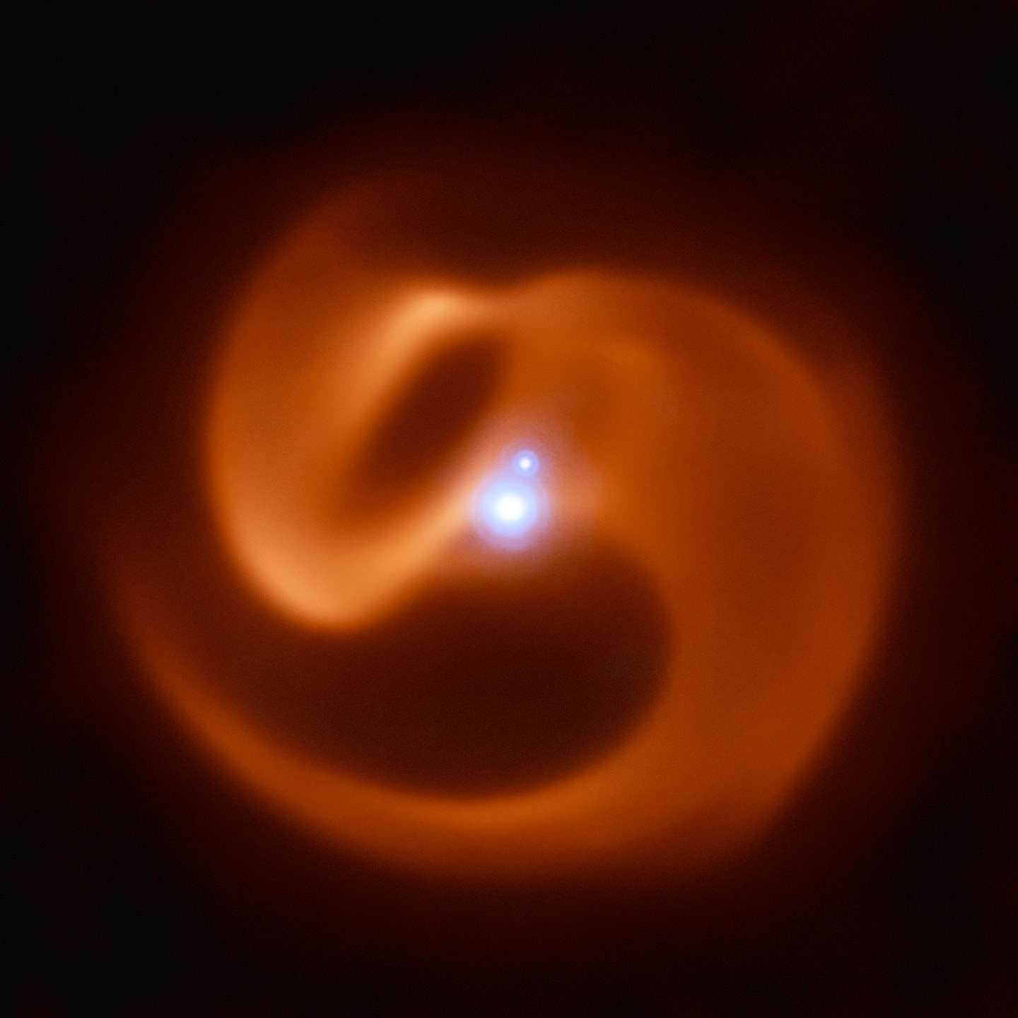 Coils of Apep The VISIR instrument on ESO’s VLT captured this stunning image of a newly-discovered massive binary star system. Nicknamed Apep after an ancient Egyptian deity, it could be the first gamma-ray burst progenitor to be found in our galaxy.  Apep’s stellar winds have created the dust cloud surrounding the system, which consists of a binary star with a fainter companion. With 2 Wolf-Rayet stars orbiting each other in the binary, the serpentine swirls surrounding Apep are formed by the collision of two sets of powerful stellar winds, which create the spectacular dust plumes seen in the image.  The reddish pinwheel in this image is data from the VISIR instrument on ESO’s Very Large Telescope (VLT), and shows the spectacular plumes of dust surrounding Apep. The blue sources at the centre of the image are a triple star system — which consists of a binary star system and a companion single star bound together by gravity. Though only two star-like objects are visible in the image, the lower source is in fact an unresolved binary Wolf-Rayet star. The triple star system was captured by the NACOadaptive optics instrument on the VLT.  Credit: ESO/Callingham et al.
