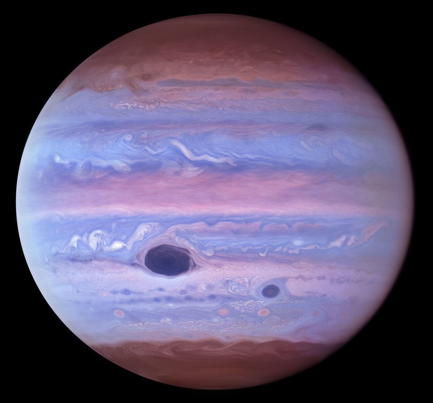 This ultraviolet image of Jupiter was created from data captured on 11 January 2017 using the Wide Field Camera 3 on the Hubble Space Telescope. The Great Red Spot and Red Spot Jr. (also known as Oval BA) absorb ultraviolet radiation from the Sun and therefore appear dark in this view.  Credit: NASA/ESA/NOIRLab/NSF/AURA/M.H. Wong and I. de Pater (UC Berkeley) et al. Acknowledgments: M. Zamani