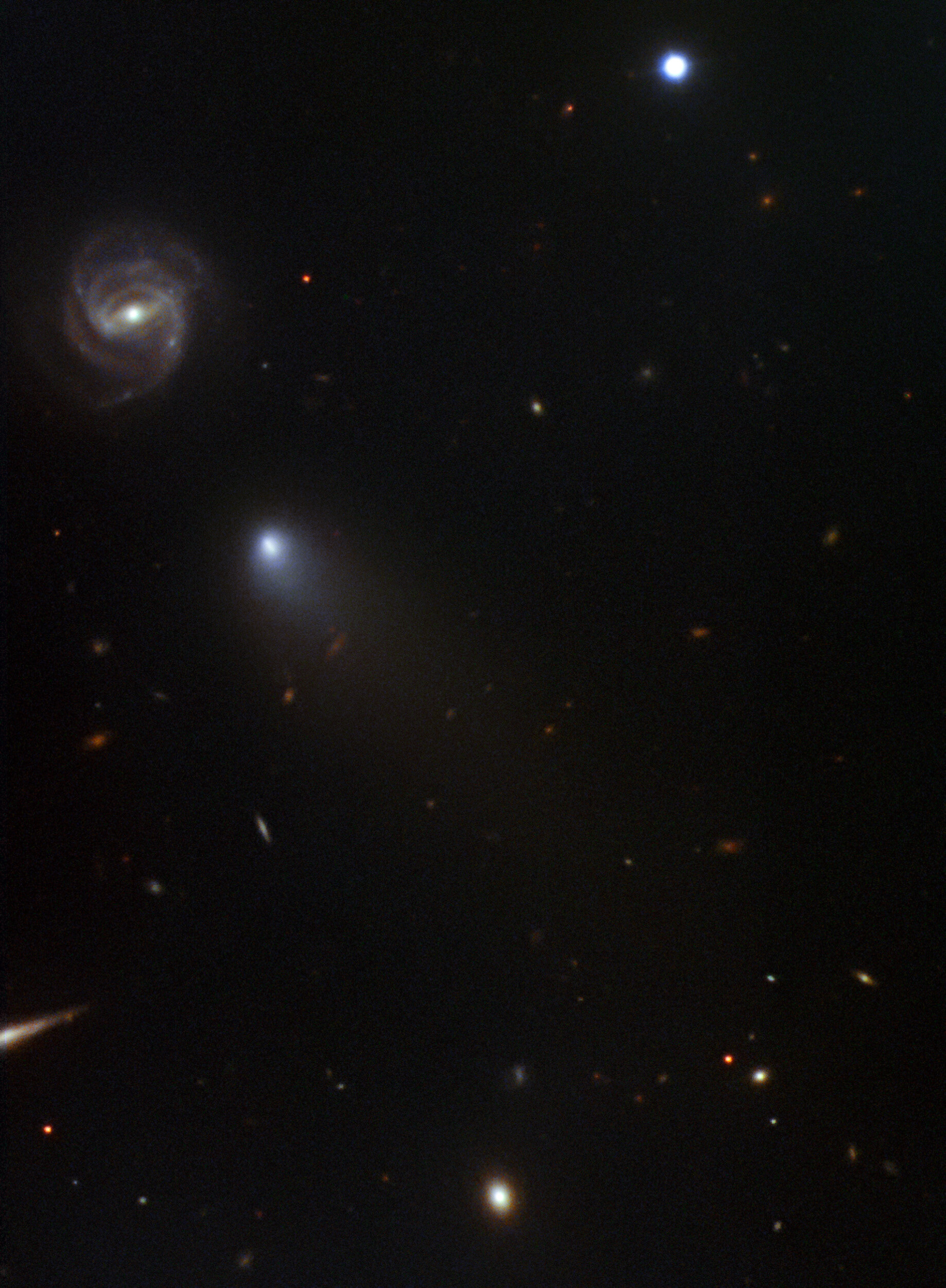 NOIRLab’s International Gemini Observatory continues tracking a visiting comet from beyond our Solar System. Gemini’s second image release of the comet, discovered by Russian amateur astronomer Gennady Borisov in August of this year, reveals the evolution of the comet as it approaches its closest approach to our sun in December. The image also features the distant background galaxy (going by the catchy designation: 2dFGRS TGN363Z174) that happened to appear adjacent to the comet when the image was captured on the night of November 11–12 2019.  “The comet is doing what we would expect a comet to do as it approaches the Sun,” according to Meg Schwamb of Queen’s University Belfast who led the observations. “Gas is being vaporized and the gas cloud, or coma, is expanding and being blown away from the Sun. It’s reassuring that comets from beyond our Solar System behave as we would expect!” Schwamb’s team obtained the image as part of a Fast Turnaround program using the Gemini North telescope and a brand new rapid data reduction pipeline called Dragons.  “Dragons allowed us to reduce these data in less than 24 hours which is critical when tracking something which evolves as quickly as a comet,” said Rosemary Pike who is a member of the team from Taiwan’s Academia Sinica Institute of Astronomy and Astrophysics.   The data are part of a long-term program to observe the visiting comet and understand how this visitor from beyond our Solar System might differ from comets originating within our own planetary system. A previous image of the comet, obtained with the Gemini North telescope was released on September 13th and was one of the first images released of the comet. The previous image is available here.  Credit: International Gemini Observatory/NSF’s National Optical-Infrared Astronomy Research Laboratory/AURA