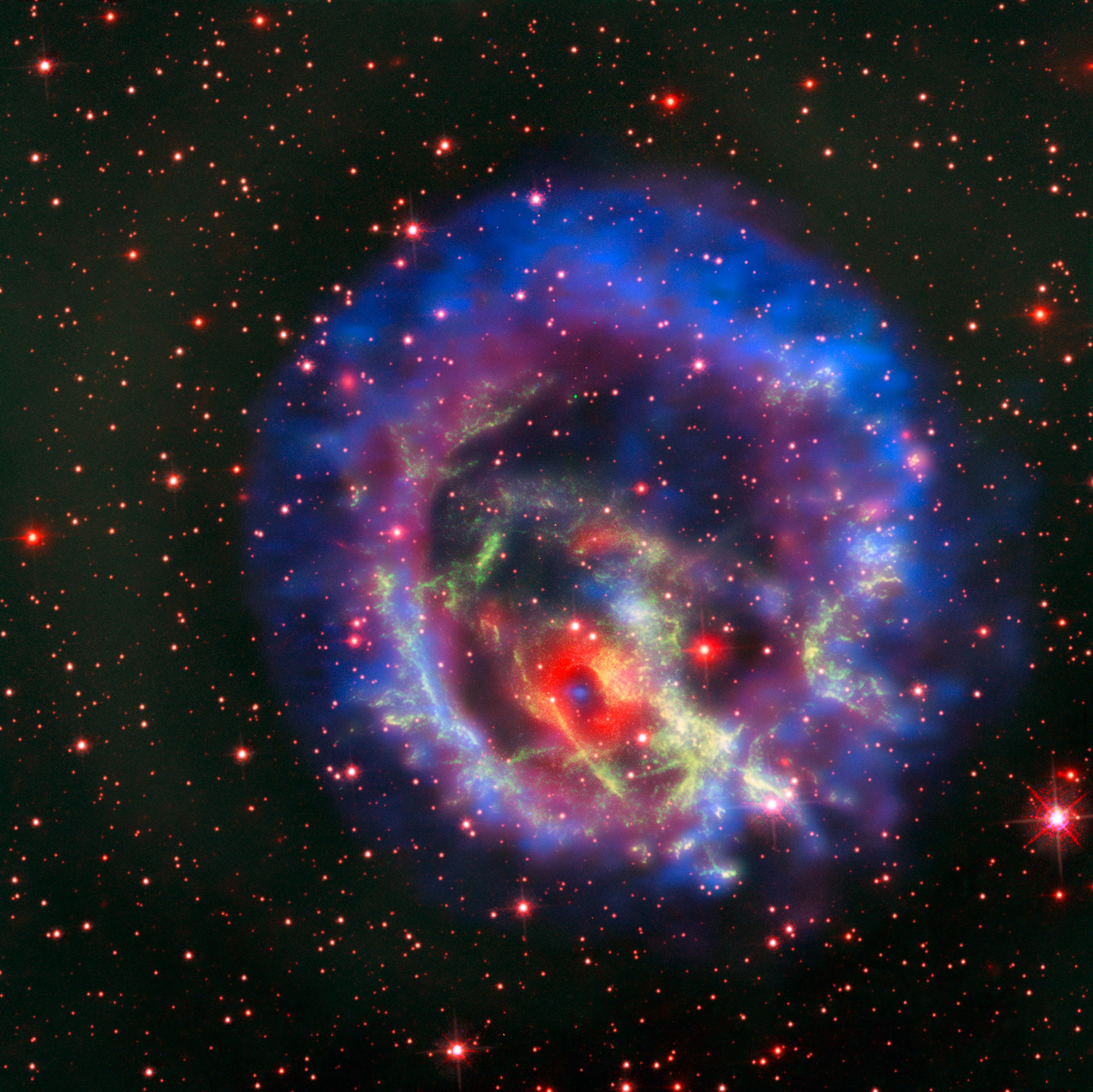 An isolated neutron star in the Small Magellanic Cloud An isolated neutron star in the Small Magellanic Cloud This new picture created from images from telescopes on the ground and in space tells the story of the hunt for an elusive missing object hidden amid a complex tangle of gaseous filaments in one of our nearest neighbouring galaxies, the Small Magellanic Cloud.  The reddish background image comes from the NASA/ESA Hubble Space Telescope and reveals the wisps of gas forming the supernova remnant 1E 0102.2-7219 in green. The red ring with a dark centre is from the MUSE instrument on ESO’s Very Large Telescope and the blue and purple images are from the NASA Chandra X-Ray Observatory. The blue spot at the centre of the red ring is an isolated neutron star with a weak magnetic field, the first identified outside the Milky Way.  Credit: ESO/NASA, ESA and the Hubble Heritage Team (STScI/AURA)/F. Vogt et al.