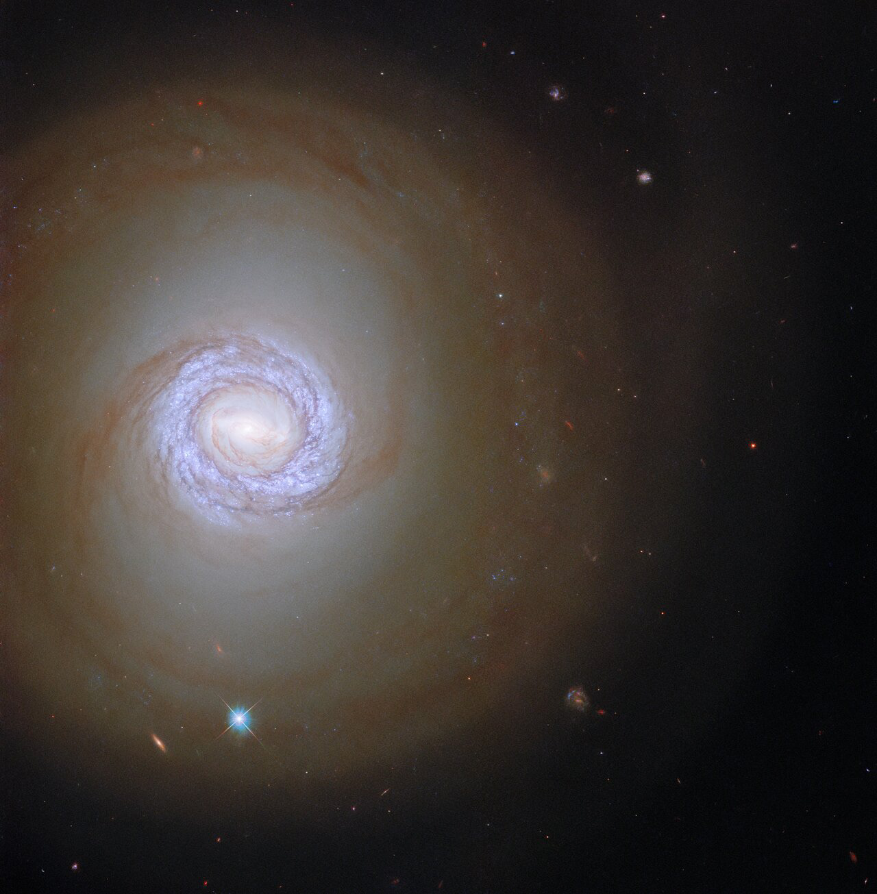 In this image the NASA/ESA Hubble Space Telescope peers into the spiral galaxy NGC 1317 in the constellation Fornax, more than 50 million light-years from Earth. This galaxy is one of a pair, but NGC 1317’s rowdy larger neighbour NGC 1316 lies outside Hubble’s field of view. Despite the absence here of its neighbouring galaxy, NGC 1317 is accompanied in this image by two objects from very different parts of the Universe. The bright point ringed with a criss-cross pattern is a star from our own galaxy surrounded by diffraction spikes, whereas the redder elongated smudge is a distant galaxy lying far beyond NGC 1317.  The data presented in this image are from a vast observing campaign of hundreds of observations from Hubble’s Wide Field Camera 3 and Advanced Camera for Surveys. Combined with data from the ALMA array in the Atacama desert, these observations help astronomers chart the connections between vast clouds of cold gas and the fiercely hot young stars that form within them. ALMA’s unparalleled sensitivity at long wavelengths identified vast reservoirs of cold gas throughout the local Universe, and Hubble’s sharp vision pinpointed clusters of young stars, as well as measuring their ages and masses.   Often the most exciting astronomical discoveries require this kind of telescope teamwork, with cutting-edge facilities working together and providing astronomers with information across the electromagnetic spectrum. The same applies to future telescopes, with Hubble’s observations laying the groundwork for future science with the NASA/ESA/CSA James Webb Space Telescope.  Links Video One of a Pair Credit: ESA/Hubble & NASA, J. Lee and the PHANGS-HST Team