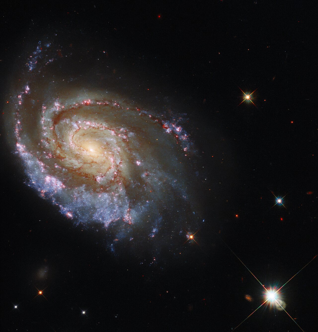 This NASA/ESA Hubble Space Telescope Picture of the Week features the galaxy NGC 6984, an elegant spiral galaxy in the constellation Indus roughly 200 million light-years away from Earth. The galaxy is a familiar sight for Hubble, having already been captured in 2013. The sweeping spiral arms are threaded through with a delicate tracery of dark lanes of gas and dust, and studded with bright stars and luminous star-forming regions.  These new observations were made following an extremely rare astronomical event — a double supernova in NGC 6984. Supernovae are unimaginably violent explosions on a truly vast scale, precipitated by the deaths of massive stars. These events are powerful but rare and fleeting — a single supernova can outshine its host galaxy for a brief time. The discovery of two supernovae at virtually the same time and location (in astronomical terms) prompted speculation from astronomers that the two supernovae may somehow be physically linked. Using optical and ultraviolet observations from Hubble’s Wide Field Camera 3, astronomers sought to get a better look at the site of the two supernovae, hopefully allowing them to discover if the two supernova explosions were indeed linked. Their findings could give astronomers important clues into the lives of binary stars.  As well as helping to unravel an astronomical mystery, these new observations added more data to the 2013 observations, and allowed this striking new image to be created. The observations — each of which covers only a narrow range of wavelengths — add new details and a greater range of colours to the image.  Links Video of Cosmic Fireworks Credit: ESA/Hubble & NASA, D. Milisavljevic