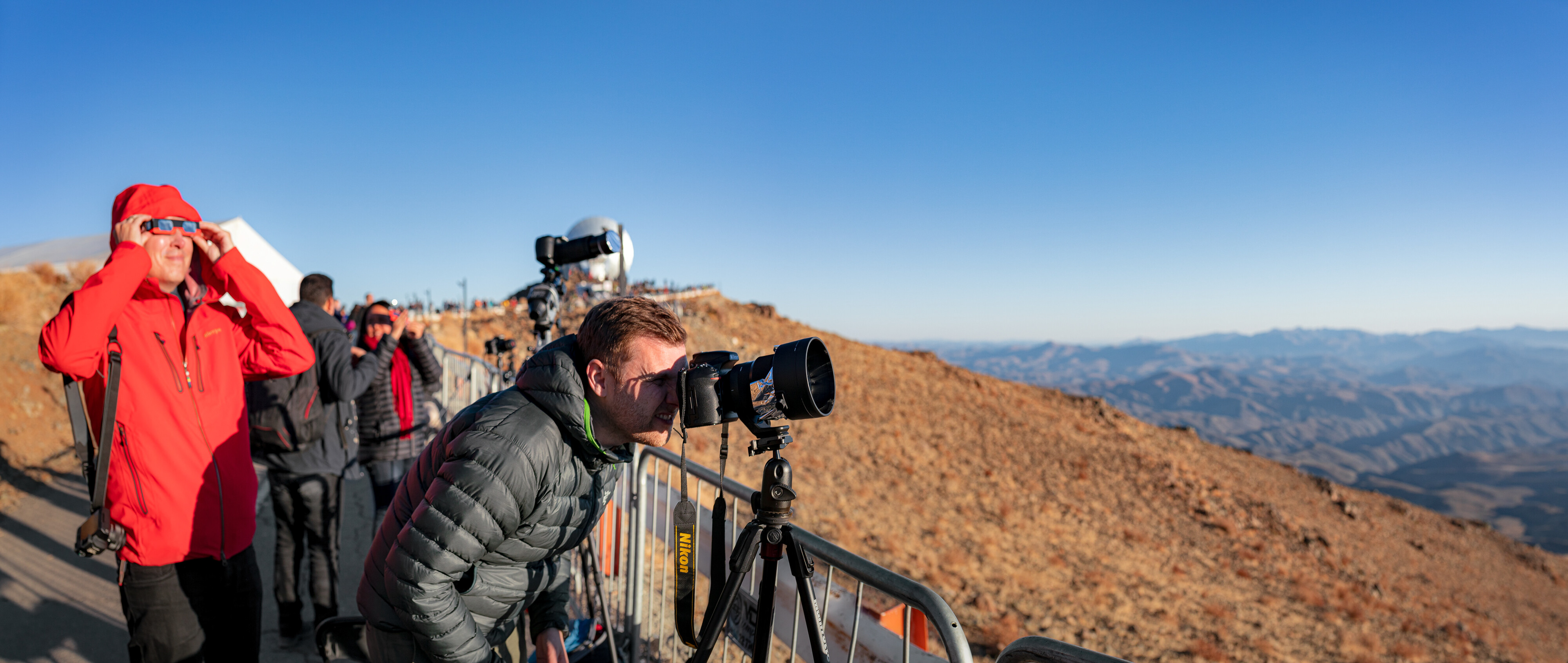 Sævar Helgi Bragason and other photographers taking photos of the solar eclipse alongside observers enjoying the spectacle with glasses with specialist lenses. The solar eclipse event at La Silla happened on 2 July 2019. 