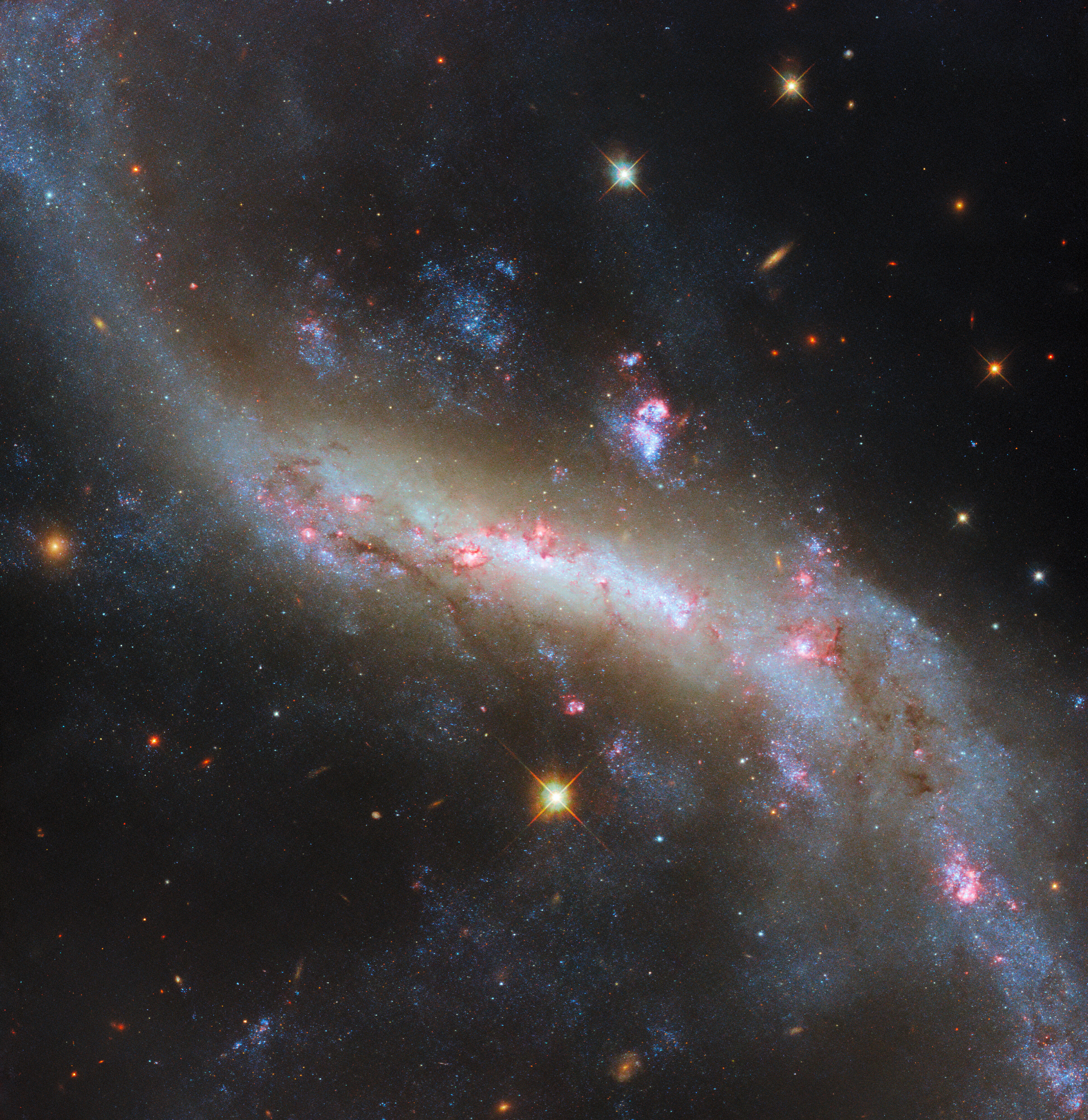 The lights of a galactic bar - Credit: ESA/Hubble & NASA, D. Thilker