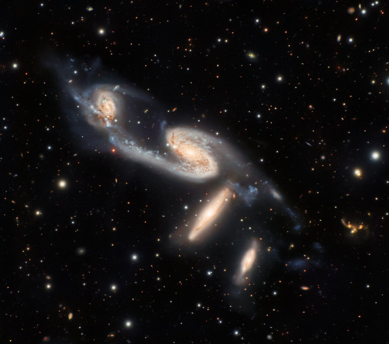 A quartet of interacting galaxies is captured in this observation from Gemini South, which is one of the twin telescopes of the International Gemini Observatory, operated by NSF’s NOIRLab. The four galaxies in this image are collectively known as NGC 6845, and lie roughly 270 million light-years from Earth in a constellation named, appropriately, Telescopium. This constellation is one of a handful named after scientific instruments rather than animals or mythological figures.  The galaxies in NGC 6845 come in two varieties: the pair of galaxies at the top of this image are well-defined spiral galaxies whereas the two below them are disk-shaped lenticular galaxies. Connecting the galaxies is evidence of star-forming regions and filaments made of stars detached from their original galaxies. Being relatively close neighbors, the galaxies in NGC 6845 are interacting. These gravitational interactions are subtly distorting the galaxies in NGC 6845, and astronomers believe that the two spiral galaxies will eventually evolve into lenticular galaxies.  Credit: International Gemini Observatory/NOIRLab/NSF/AURA/G. Gimeno, R. J. Díaz, H. Dottori Image processing: T.A. Rector (University of Alaska Anchorage/NSF’s NOIRLab), M. Zamani (NSF’s NOIRLab) & D. de Martin (NSF’s NOIRLab)