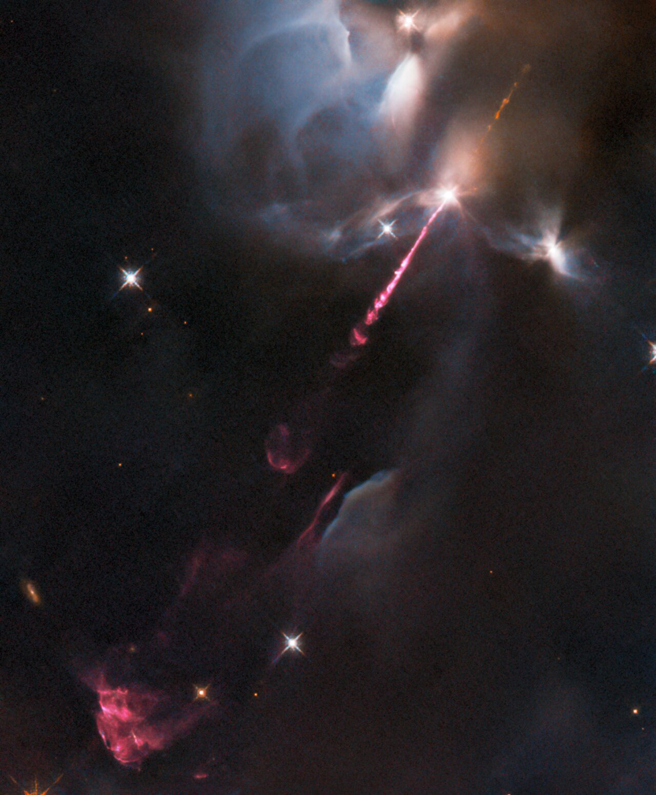 An energetic outburst from an infant star streaks across this image from the NASA/ESA Hubble Space Telescope. This stellar tantrum — produced by an extremely young star in the earliest phase of formation — consists of an incandescent jet of gas travelling at supersonic speeds. As the jet collides with material surrounding the still-forming star, the shock heats this material and causes it to glow. The result is the colourfully wispy structures, which astronomers refer to as Herbig–Haro objects, billowing across the lower left of this image.   Herbig–Haro objects are seen to evolve and change significantly over just a few years. This particular object, called HH34, was previously captured by Hubble between 1994 and 2007, and again in glorious detail in 2015. HH34 resides approximately 1250 light-years from Earth in the Orion Nebula, a large region of star formation visible to the unaided eye. The Orion Nebula is one of the closest sites of widespread star formation to Earth, and as such has been pored over by astronomers in search of insights into how stars and planetary systems are born.   The data in this image are from a set of Hubble observations of four nearby bright jets with the Wide Field Camera 3 taken to help pave the way for future science with the NASA/ESA/CSA James Webb Space Telescope. Webb — which will observe at predominantly infrared wavelengths — will be able to peer into the dusty envelopes surrounding still-forming protostars, revolutionising the study of jets from these young stars. Hubble’s high-resolution images of HH34 and other jets will help astronomers interpret future observations with Webb.  Credit: ESA/Hubble & NASA, B. Nisini
