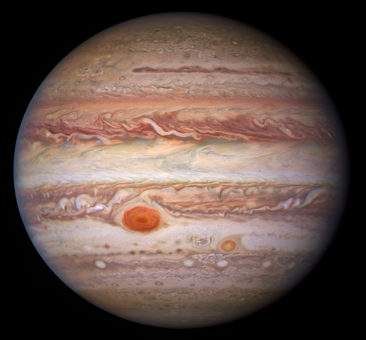 This visible-light image of Jupiter was created from data captured on 11 January 2017 using the Wide Field Camera 3 on the Hubble Space Telescope. Near the top, a long brown feature called a ‘brown barge’ extends 72,000 kilometers (nearly 45,000 miles) in the east-west direction. The Great Red Spot stands out prominently in the lower left, while the smaller feature nicknamed Red Spot Jr. (known to Jovian scientists as Oval BA) appears to its lower right.  Credit: NASA/ESA/NOIRLab/NSF/AURA/M.H. Wong and I. de Pater (UC Berkeley) et al. Acknowledgments: M. Zamani