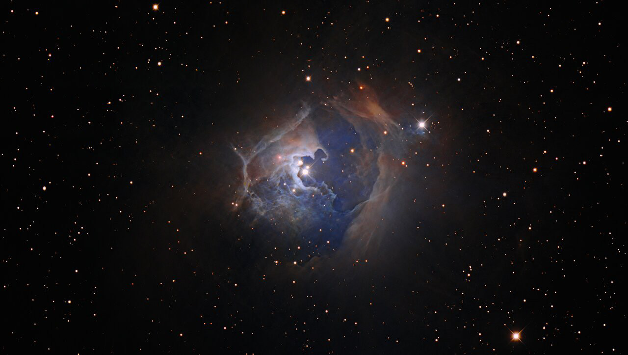 This observation captures the variable star HP Tau, which lies more than 550 light-years from Earth in the constellation Taurus. This image was created using data from the Nicholas U. Mayall 4-meter Telescope at Kitt Peak National Observatory (KPNO), a Program of NSF’s NOIRLab. HP Tau is a T Tauri star, a young and chaotic type of star that is settling into a more sedate phase of stellar life known as the main sequence. The length of time that a star spends on the main sequence will depend on its mass. Our Sun, for example, is about halfway through its roughly 10-billion-year main-sequence lifetime.  HP Tau is part of a triple star system — the three separate stars are visible at the center of this image — surrounded by a large arcing reflection nebula. These nebulae, as the name suggests, reflect the light from nearby stars rather than glowing like emission nebulae elsewhere in the Universe.  Credit: KPNO/NOIRLab/NSF/AURA/P. Massey Image processing: T.A. Rector (University of Alaska Anchorage/NSF’s NOIRLab), M. Zamani (NSF’s NOIRLab) & D. de Martin (NSF’s NOIRLab)