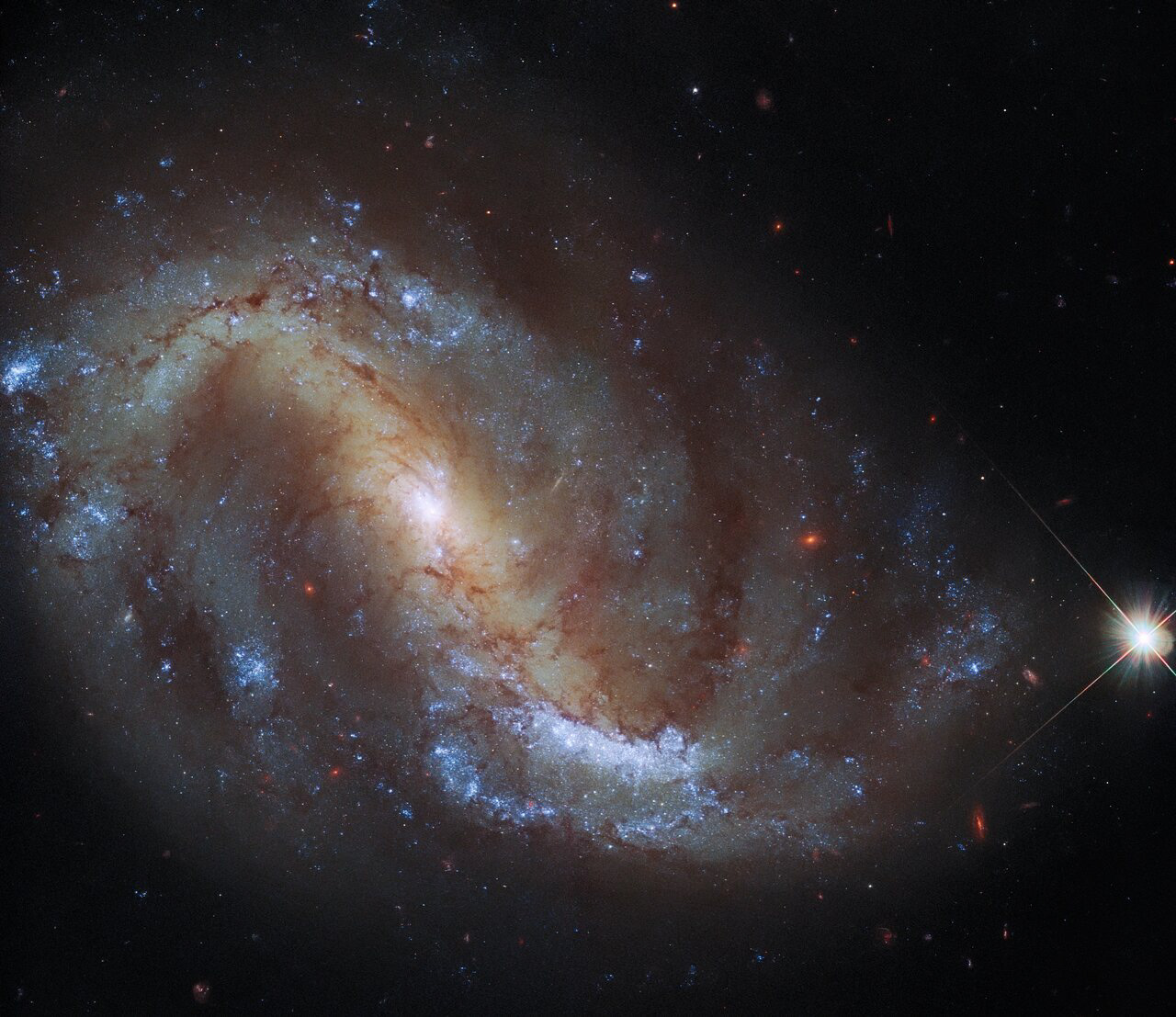 This image from the NASA/ESA Hubble Space Telescope shows the barred spiral galaxy NGC 7496, which lies over 24 million light-years away in the constellation Grus. This constellation, whose name is Latin for crane, is one of four constellations collectively known as the Southern Birds. The others are Pavo, Phoenix and Tucana, which depict a peacock, phoenix, and toucan respectively. The rest of the night sky is also home to a flock of ornithological constellations, including an eagle (Aquilla), swan (Cygnus), crow (Corvus), and dove (Columba).   This image comes from a collection of observations delving into the relationship between young stars and the cold, dense clouds of gas in which they form. In addition to observations with Hubble’s Wide Field Camera 3 and Advanced Camera for Surveys, the astronomers behind this project gathered data using the Atacama Large Millimeter/submillimeter Array (ALMA), one of the largest radio telescopes in the world.   As well as shedding light on the speed and efficiency of star formation in a variety of galactic environments, this project is also creating a treasury of data incorporating both Hubble and ALMA observations. This treasure trove of data from two of the world’s most capable observatories will contribute to wider research into star formation, as well as paving the way for future science with the James Webb Space Telescope.  Links Video of Hubble Goes Galactic Birdwatching Credit: ESA/Hubble & NASA, J. Lee and the PHANGS-HST Team Acknowledgement: J. Schmidt