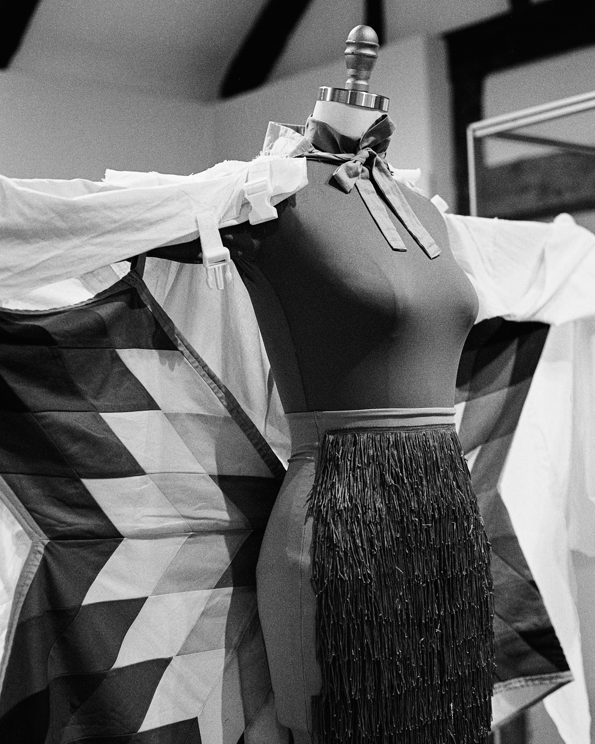 A mannequin wearing a quilted cape