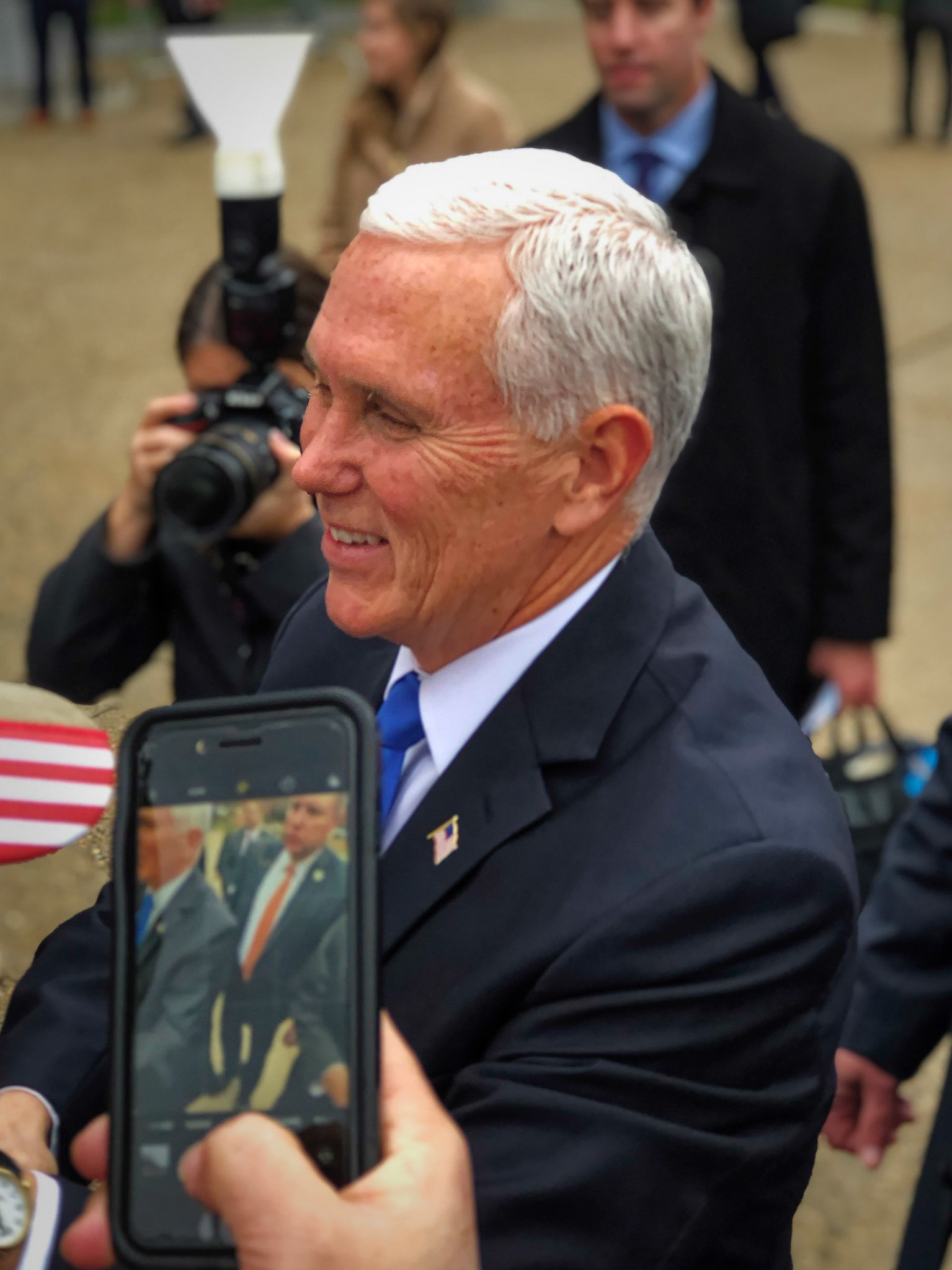 Vice President Pence smiles as a supporter takes his picture with a smartphone at Manchester, New Hampshire.