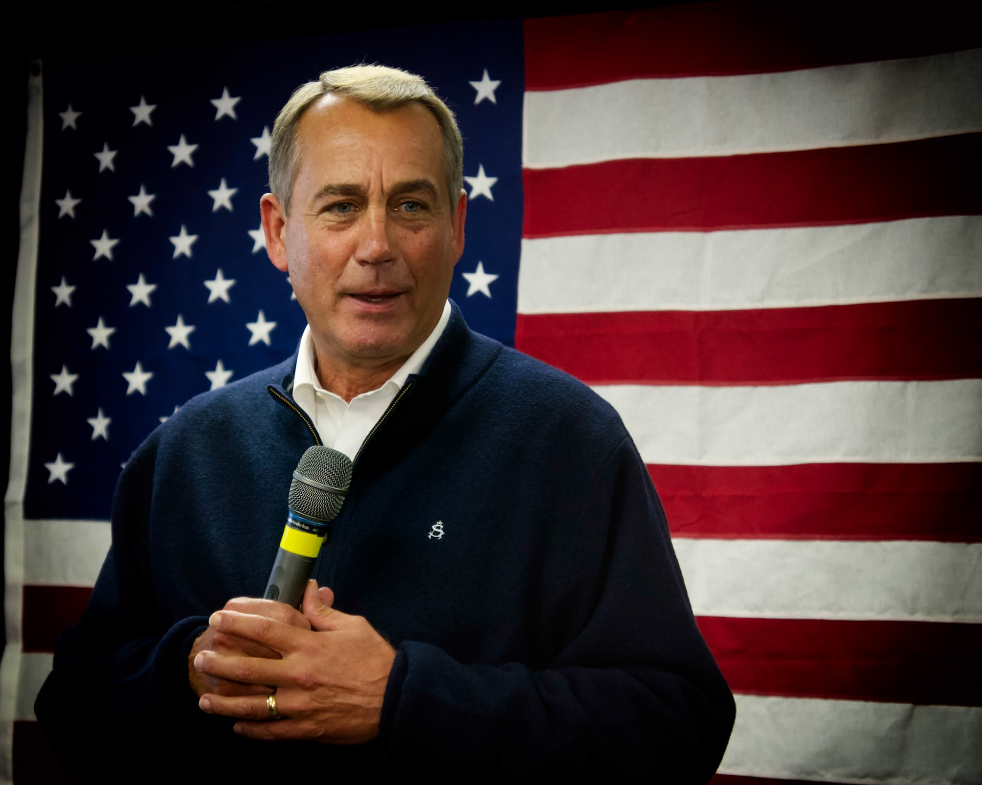 House Speaker John Boehner standing in front of an American flag speaks at a rally in Derry New, Hampshire. 