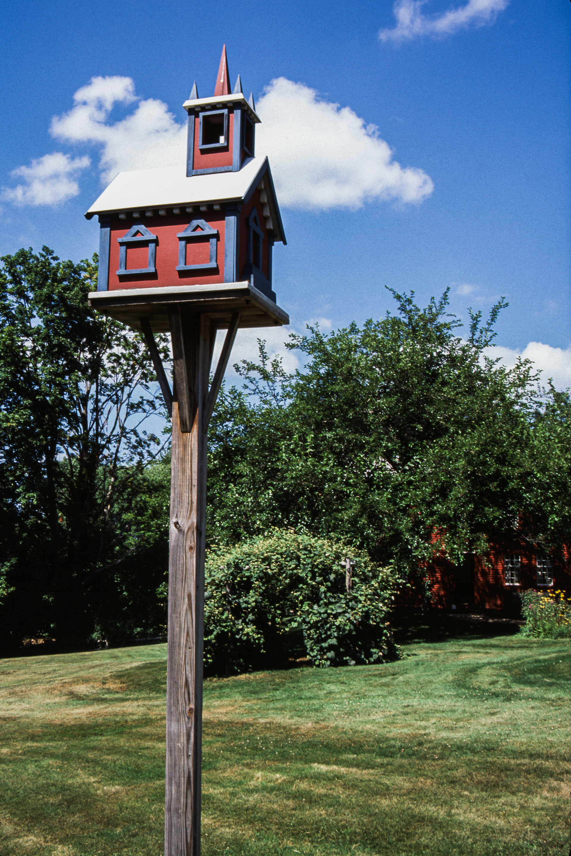 A red wooden bird house
