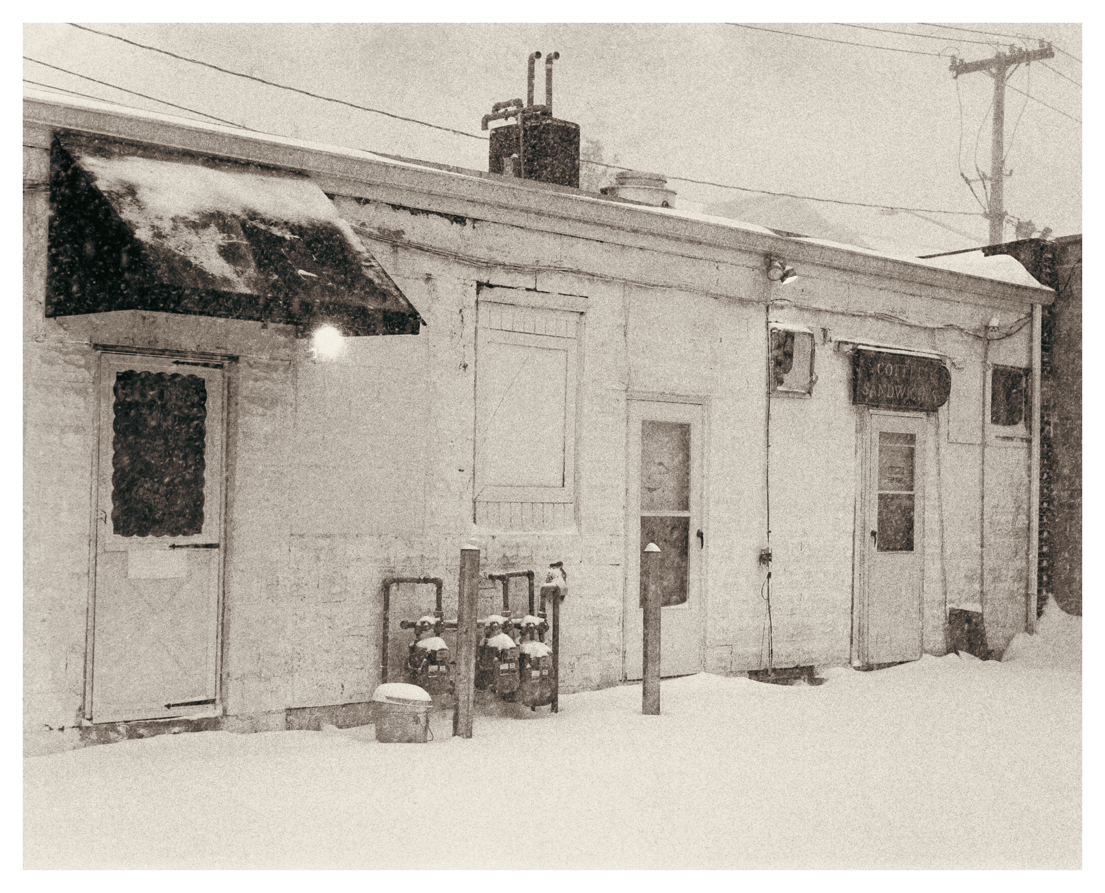 Backside of a shopping plaza during a blizzard