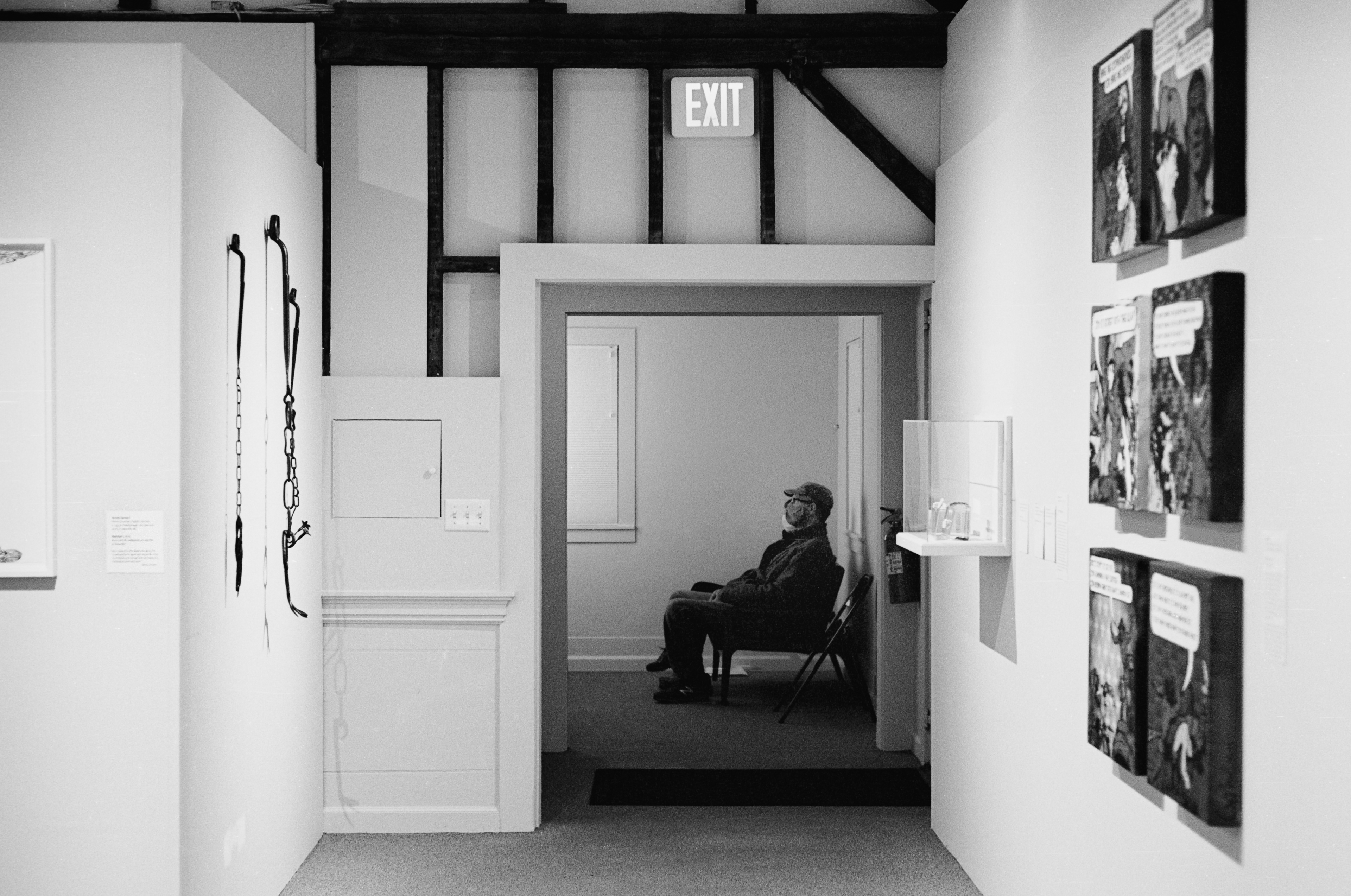 A man sits in chair watching a historical film