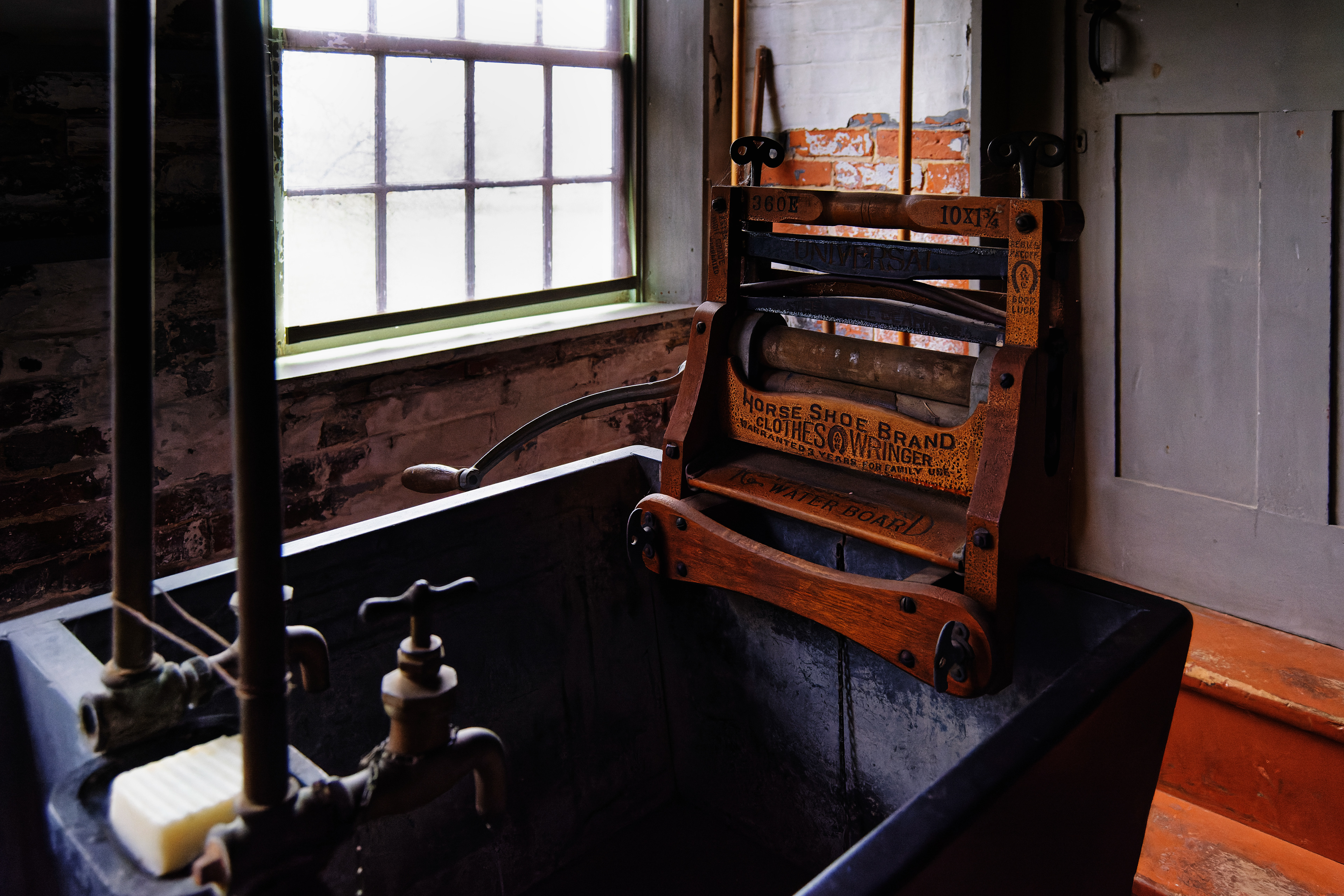 Clothing ringer on sink in laundry room