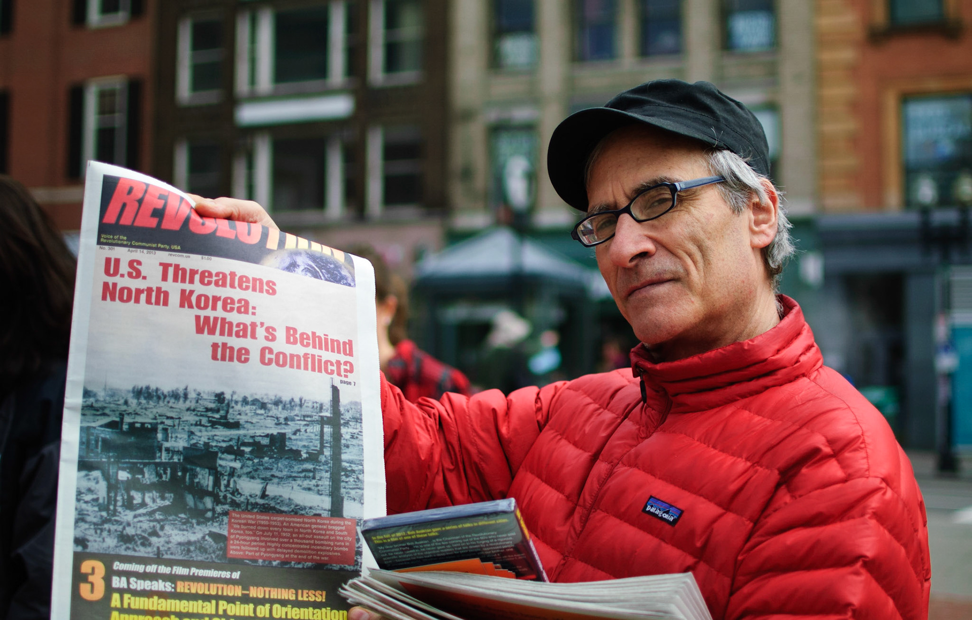 Protester sells Revolutionary Communist Party newspapers - Boston, Massachusetts.