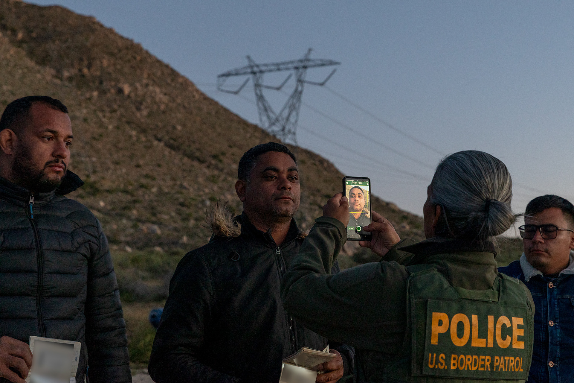 Migrants have their faces scanned by U.S. Border Patrol shortly after crossing into the U.S.