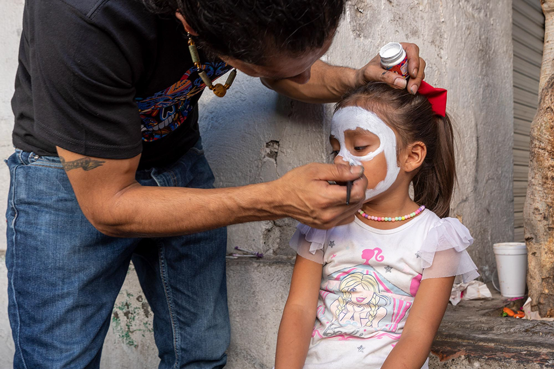 A young girl has her face painted for the Day of the Dead tradition in San Andres Míxquic.