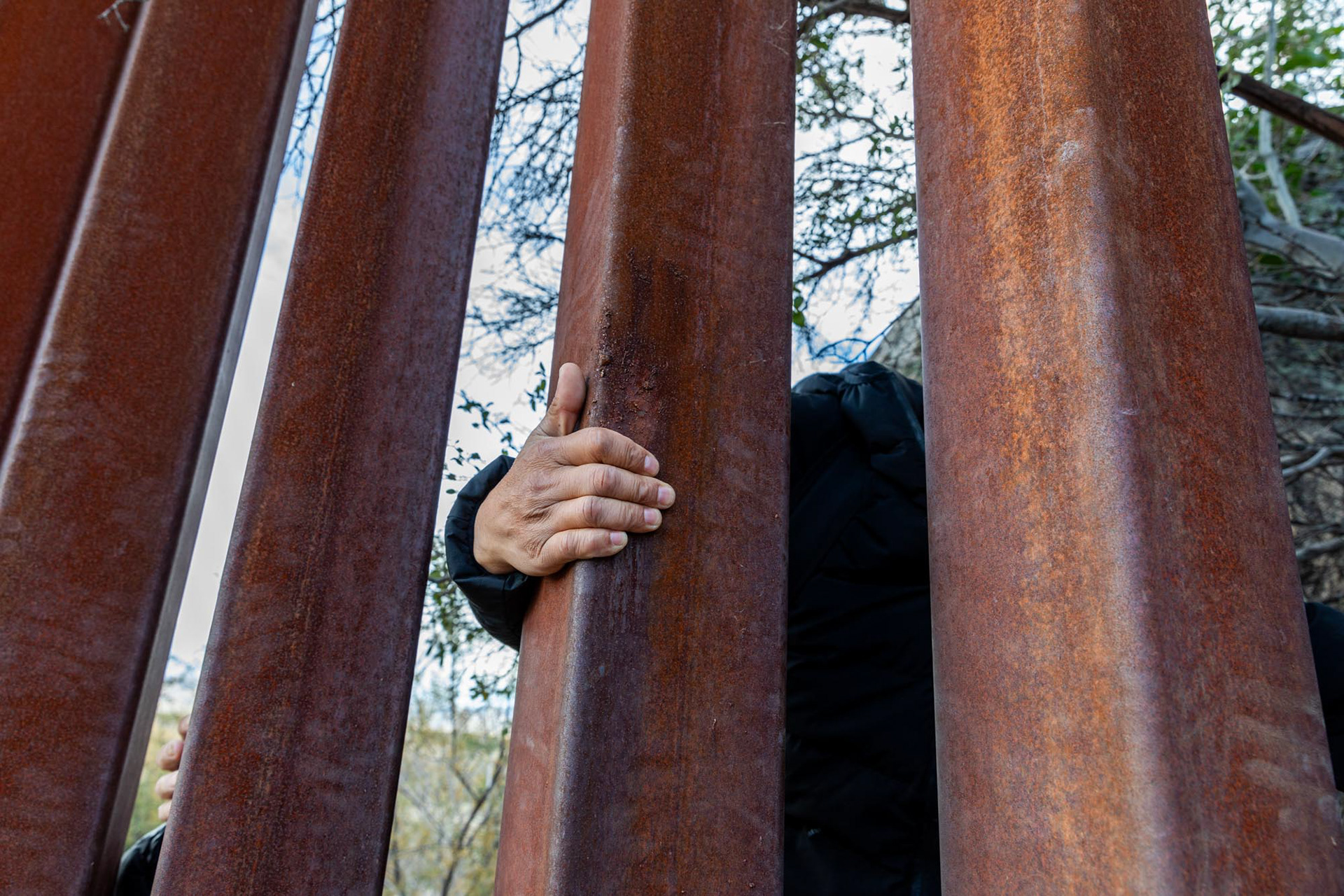 Migrants crossing the border wall from Tijuana, Mexico, into California, U.S., at Jacumba Hot Springs, CA.