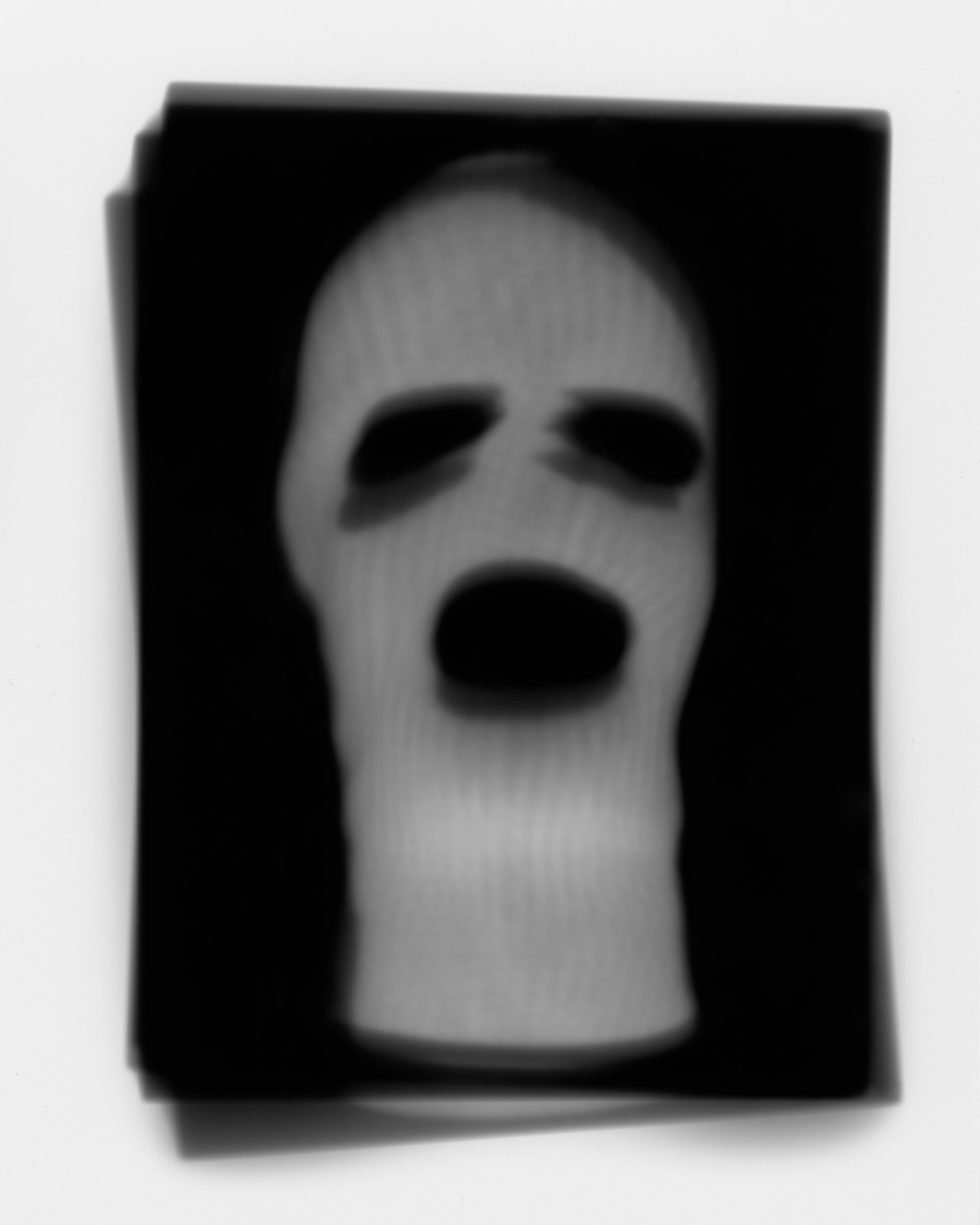 contact print photograph of a terrorist ski mask made using an iPad in the darkroom