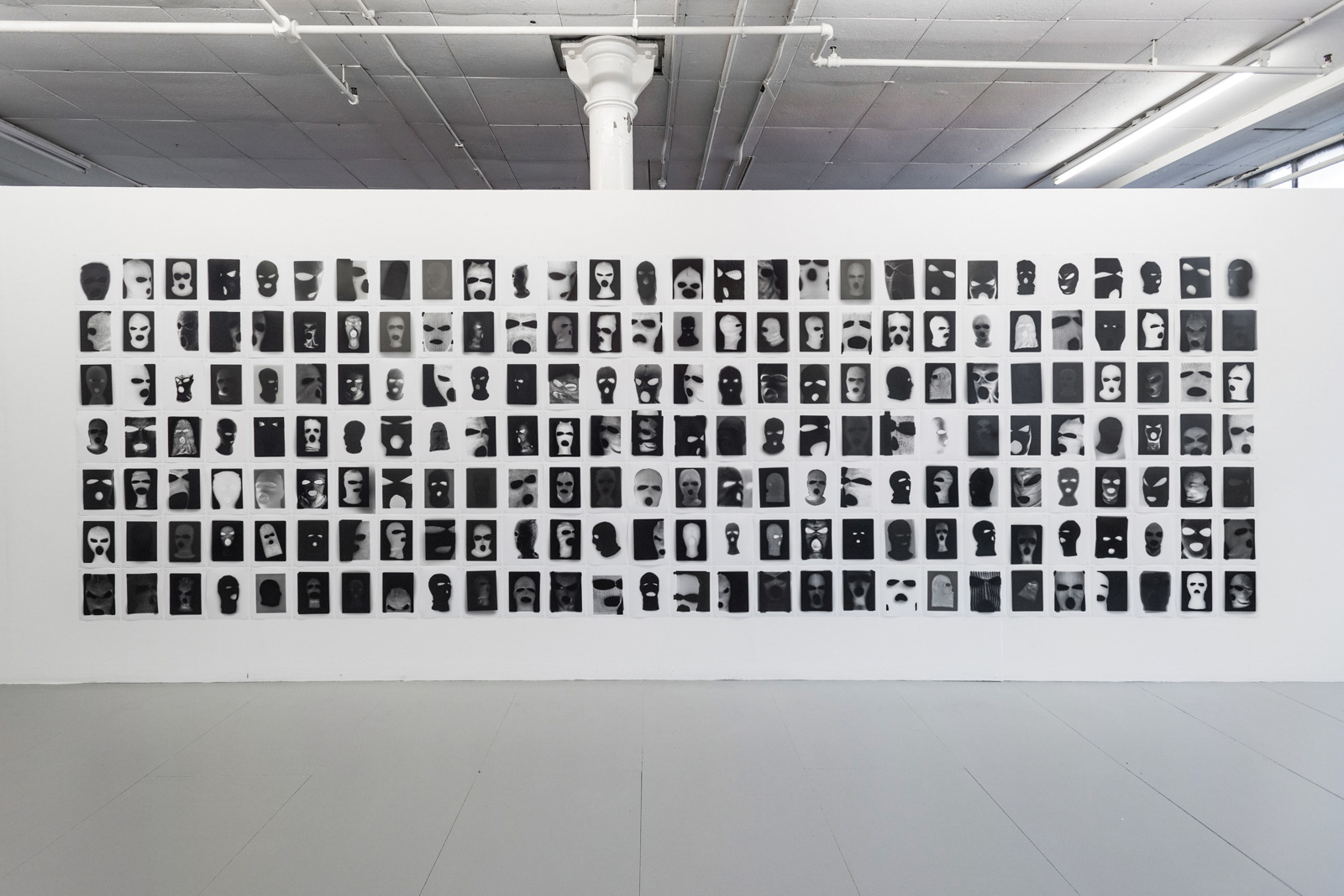 Photography installation of 198 Terrorist Masks by martin seeds at seen fifteen gallery