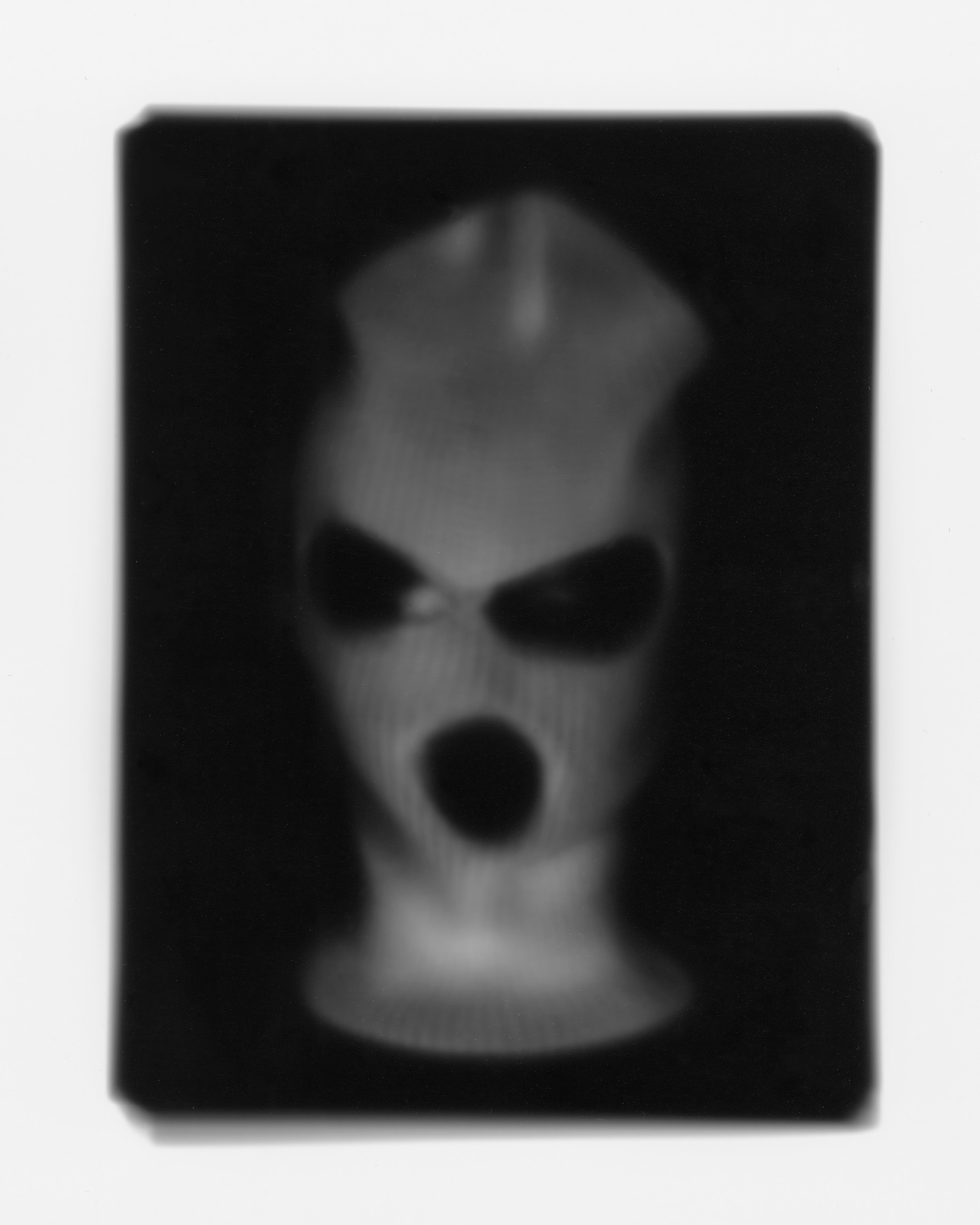 contact print photograph of a terrorist ski mask made using an iPad in the darkroom