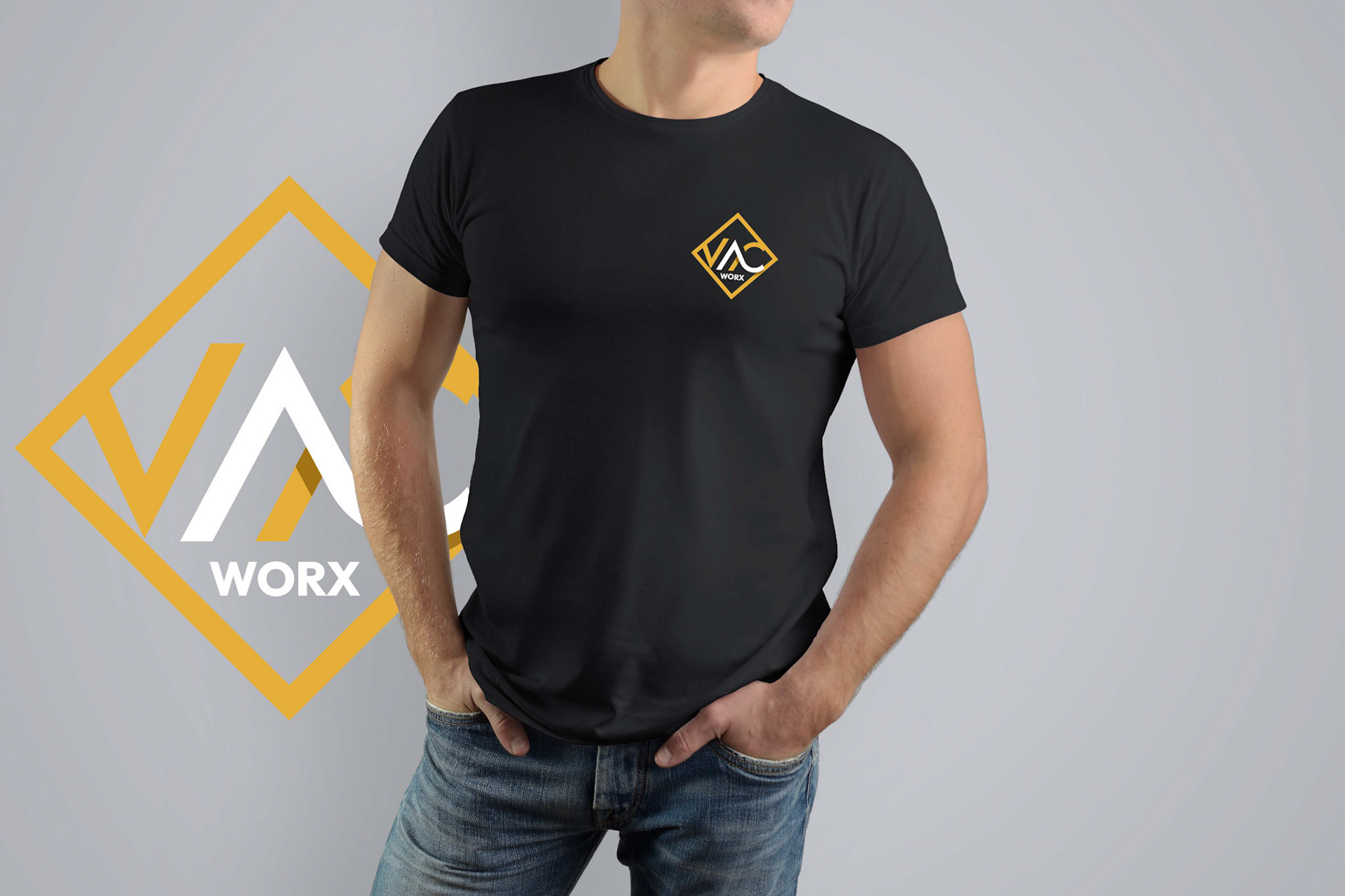 Mockup  black T-shirt on a strong man in blue jeans. Isolated on a gray background. Template can be used for your design.