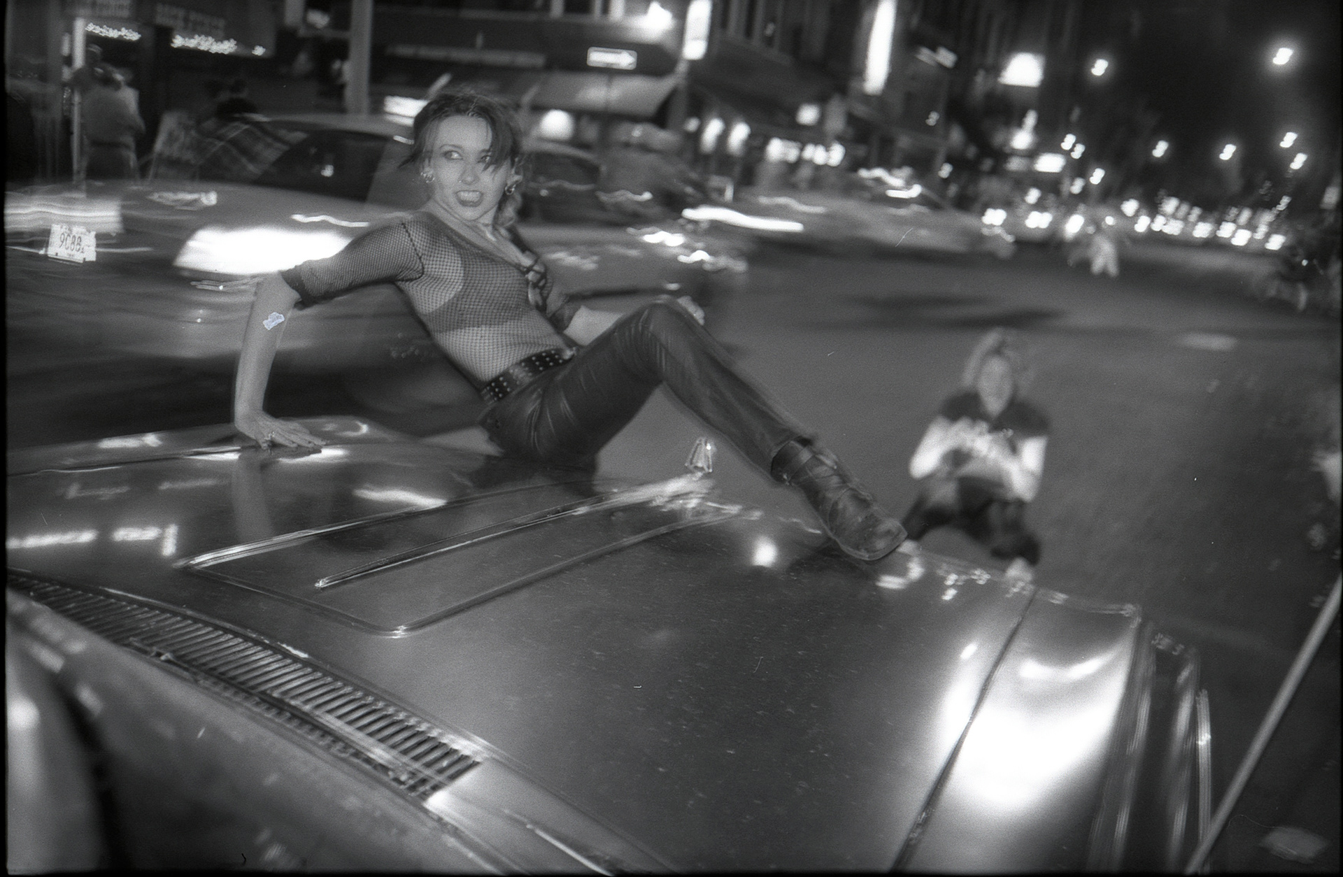 Nicolette on a car hood on Bleecker Street, Melanie Vesey in the background