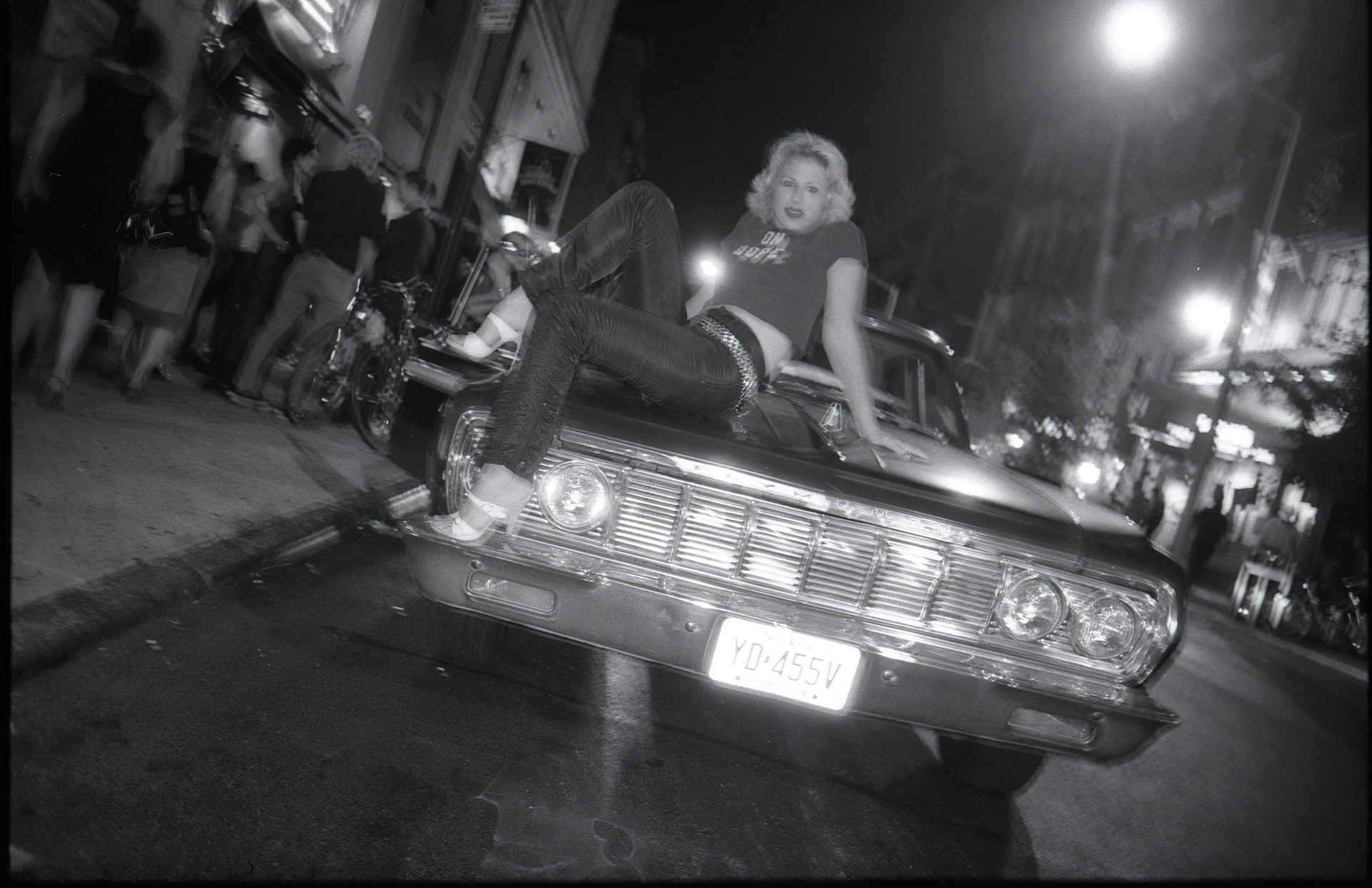 Melanie Vesey on a car hood on Bleecker Street.
